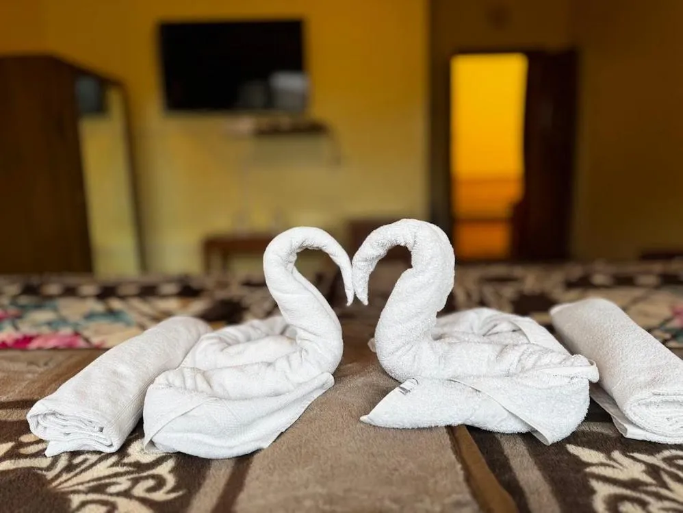 Bed in Satya Anand Cottage Pure Veg and Non Alcoholic Hotel