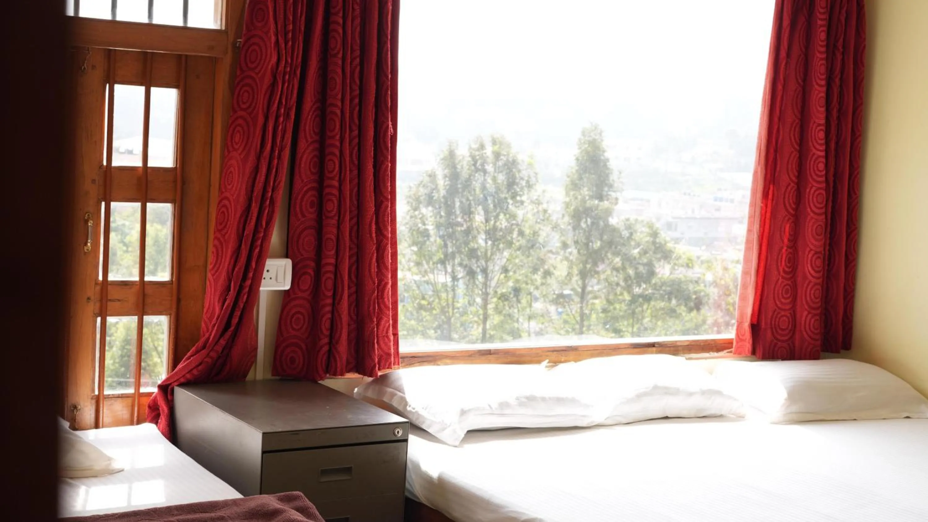 Bed in Satya Anand Cottage Pure Veg and Non Alcoholic Hotel