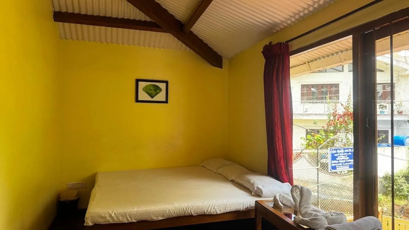 Bed in Satya Anand Cottage Pure Veg and Non Alcoholic Hotel