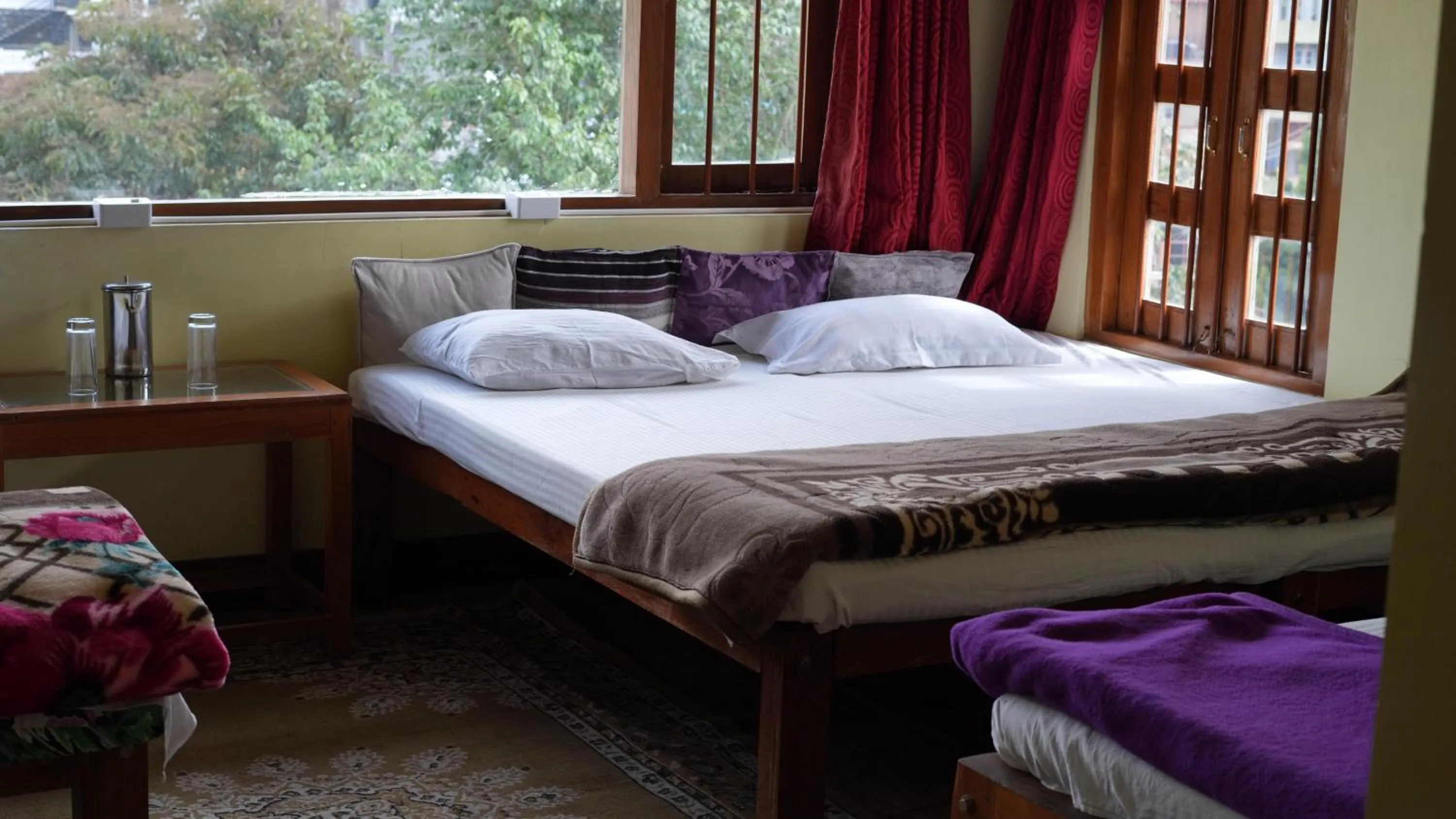 Bed in Satya Anand Cottage Pure Veg and Non Alcoholic Hotel