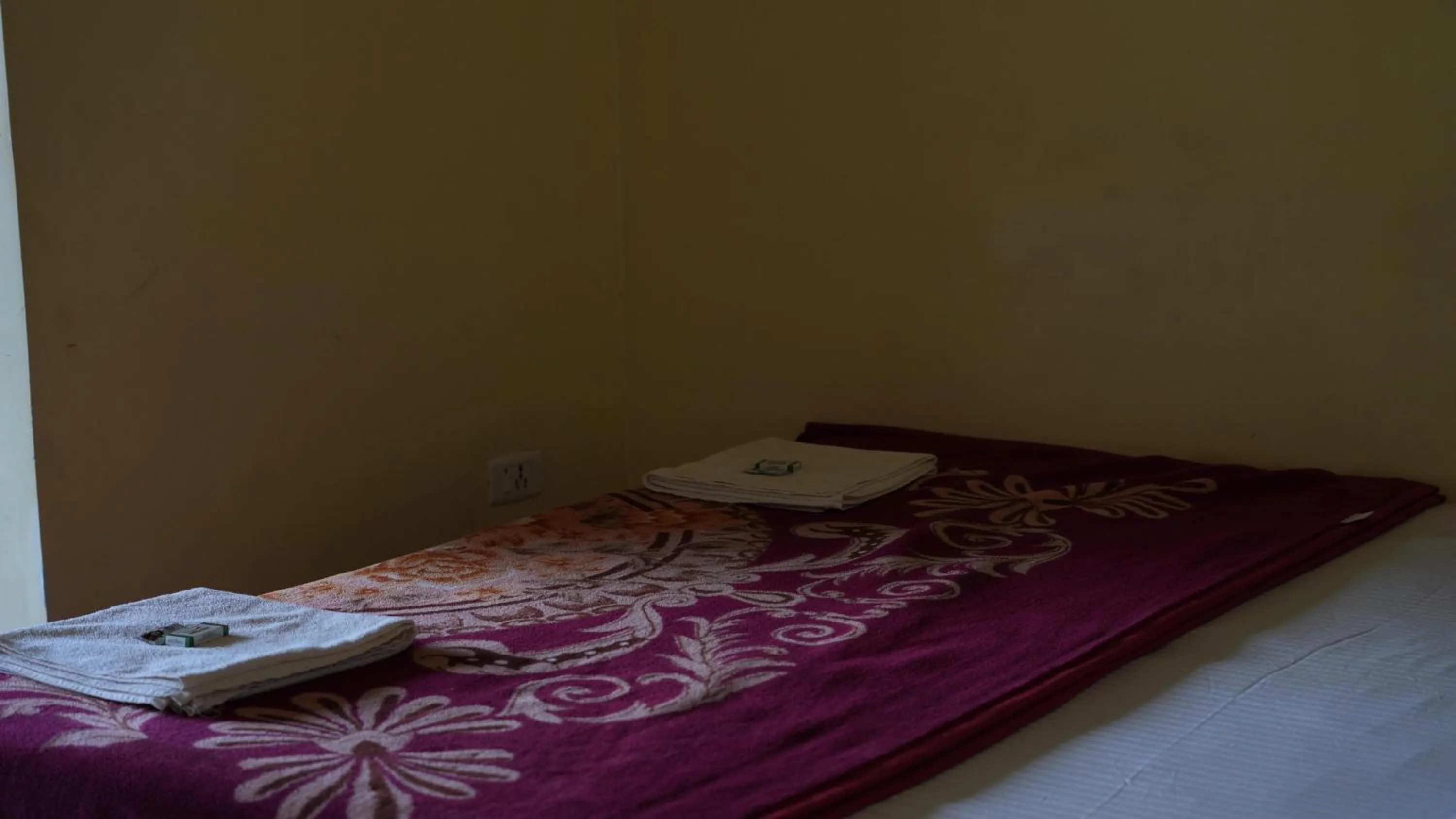 Bed in Satya Anand Cottage Pure Veg and Non Alcoholic Hotel