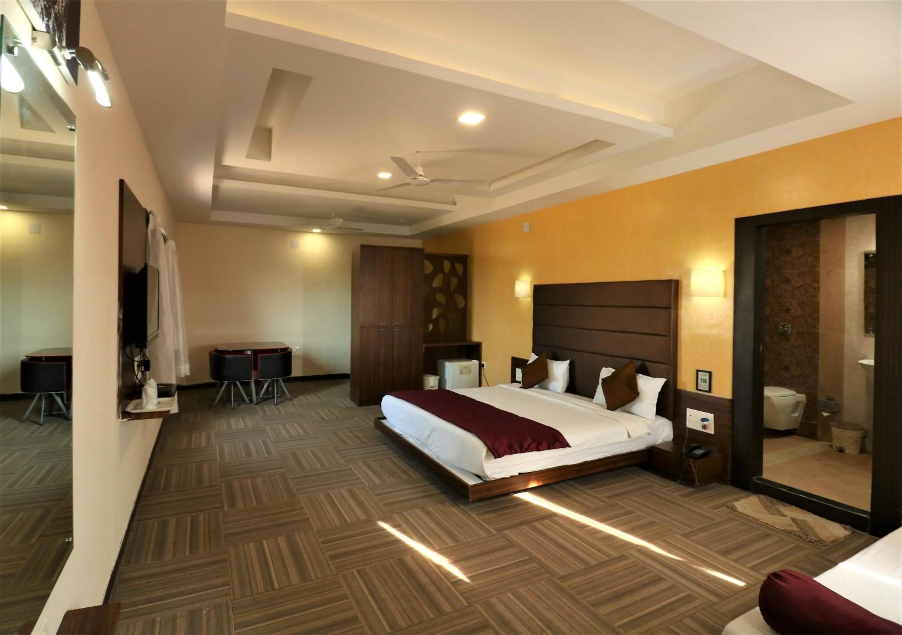 Photo of the whole room, Bed in Goverdhan Greens Resort Dwarka l Hotels In Dwarka