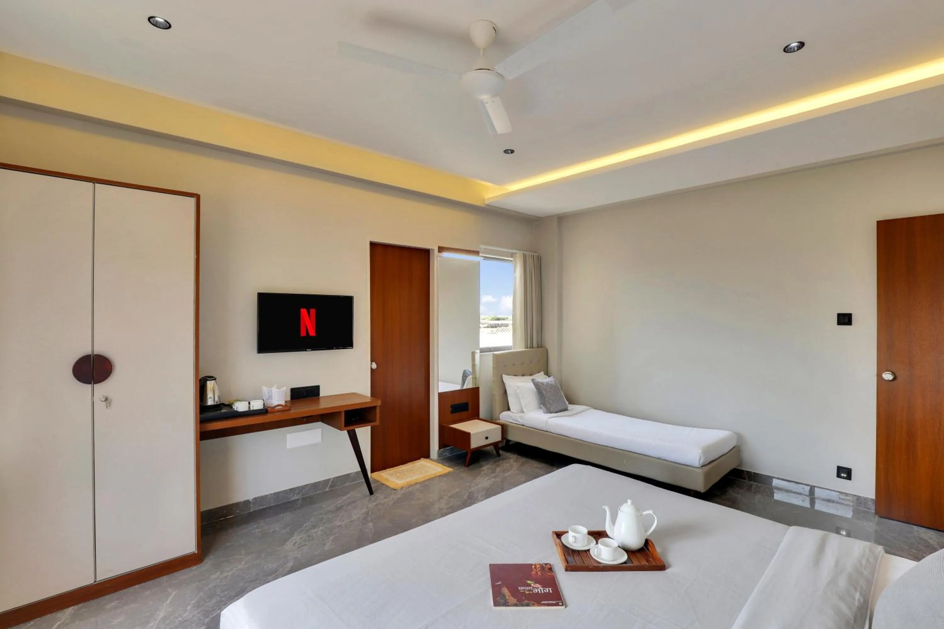 Photo of the whole room, Bed in Goverdhan Greens Resort Dwarka l Hotels In Dwarka