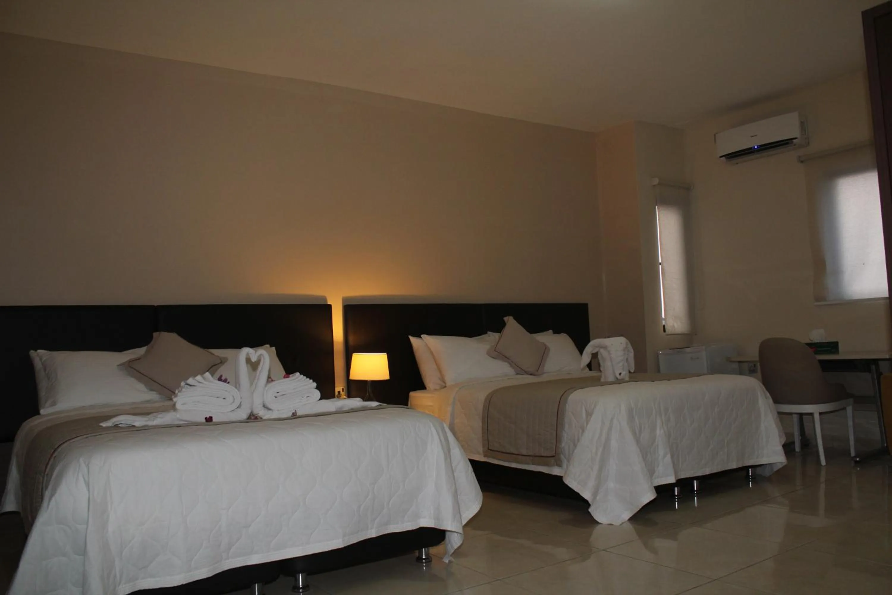 Bed in Murex Plaza Hotel & Suites