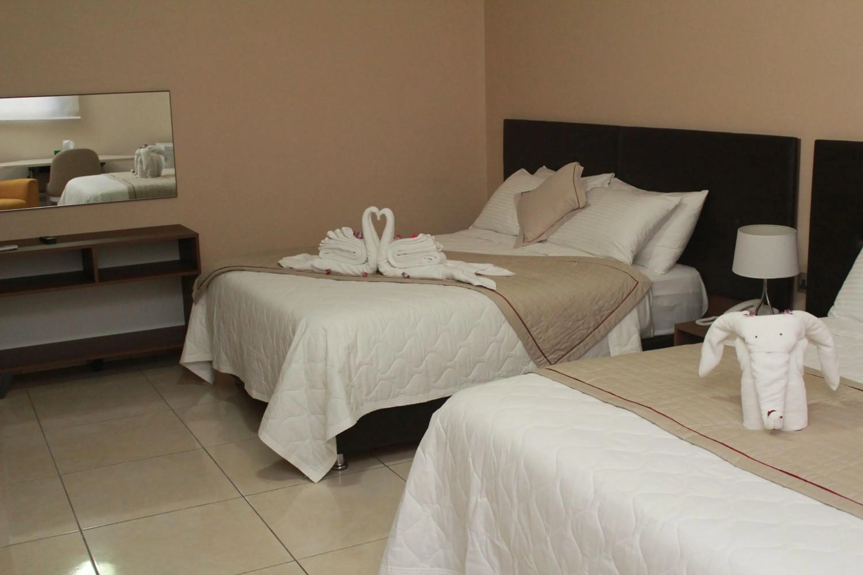 Bed in Murex Plaza Hotel & Suites