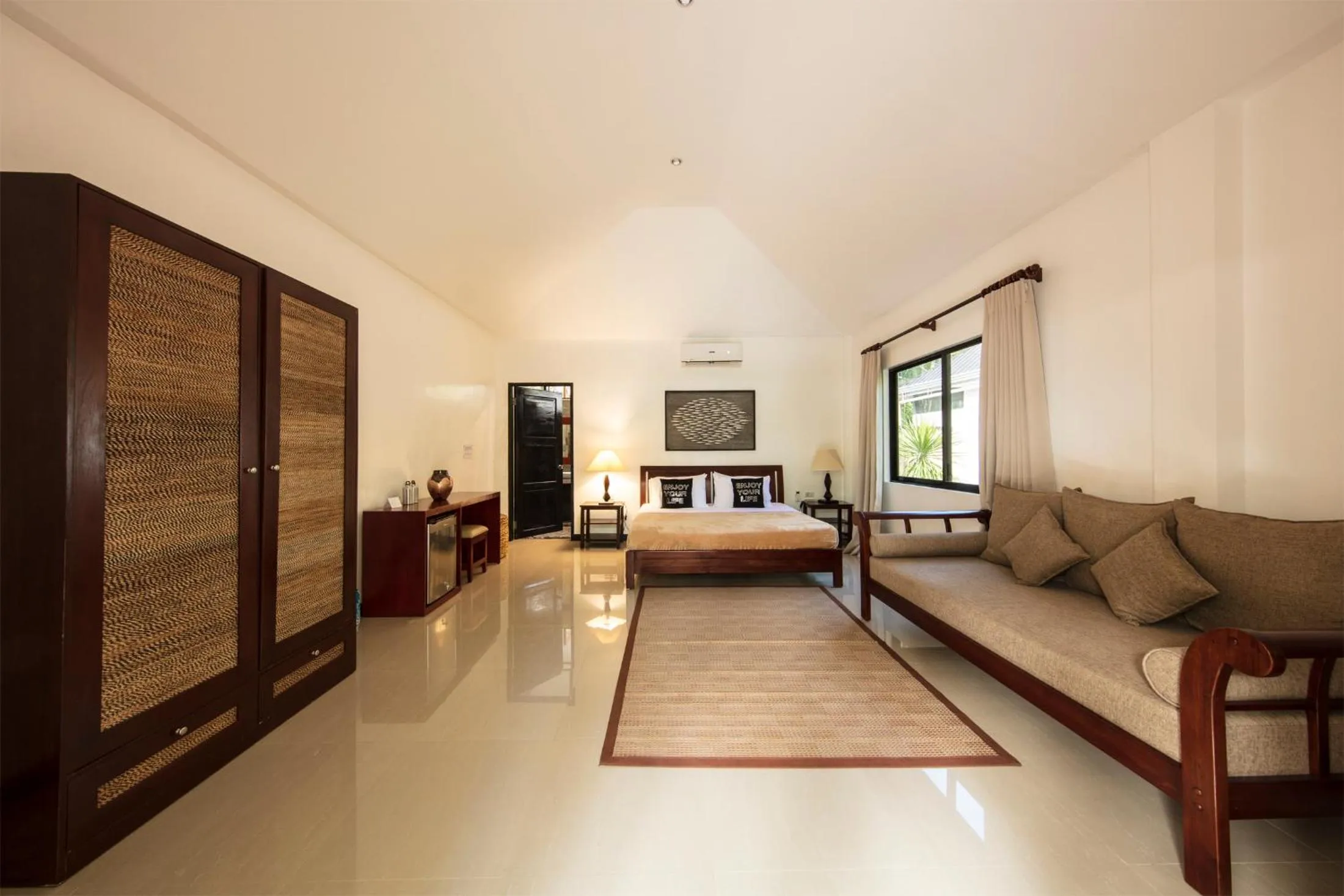 Bed in Cabilao Sanctuary Beach & Dive Resort