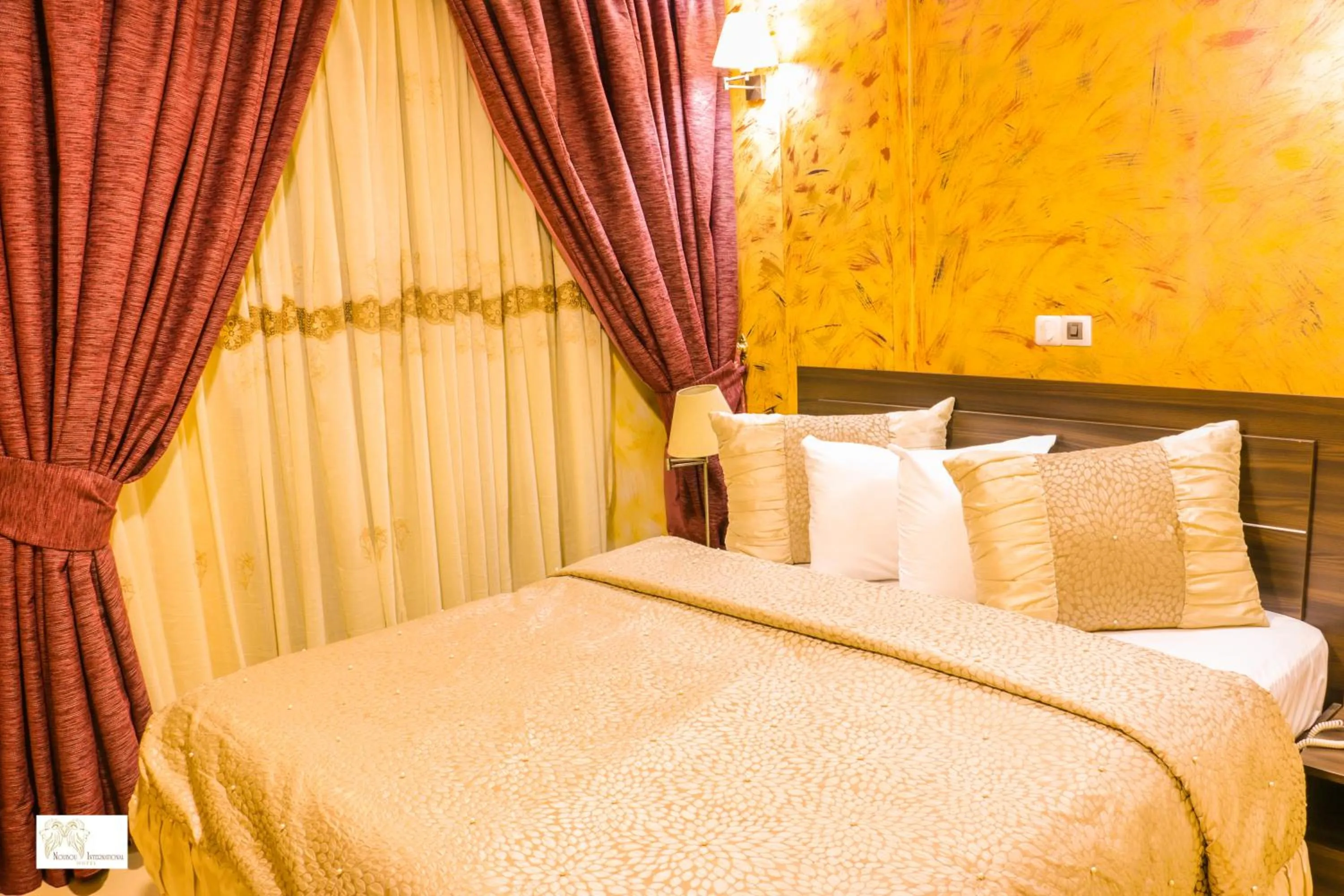Bed in Noubou International Hotel