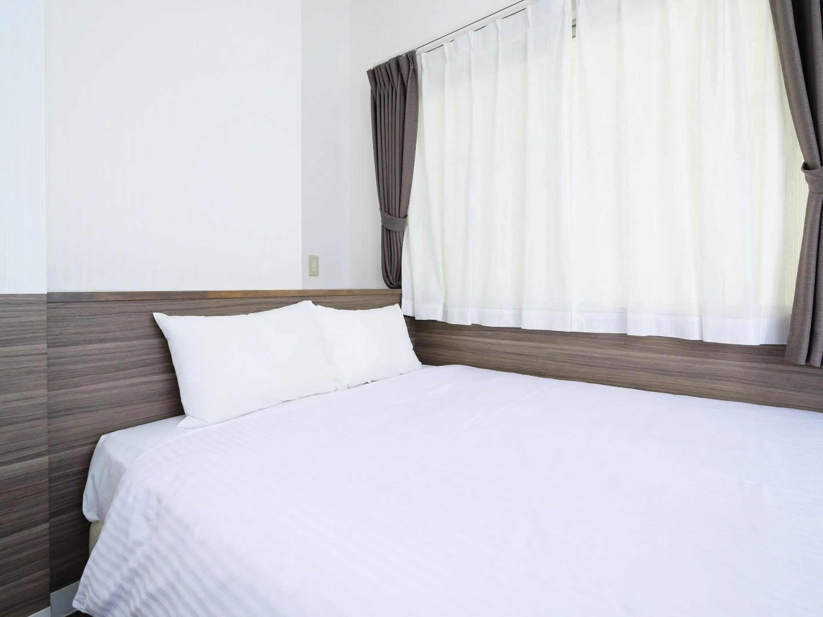 Photo of the whole room, Bed in HOTEL THE CUBE Naha Kokusai Street