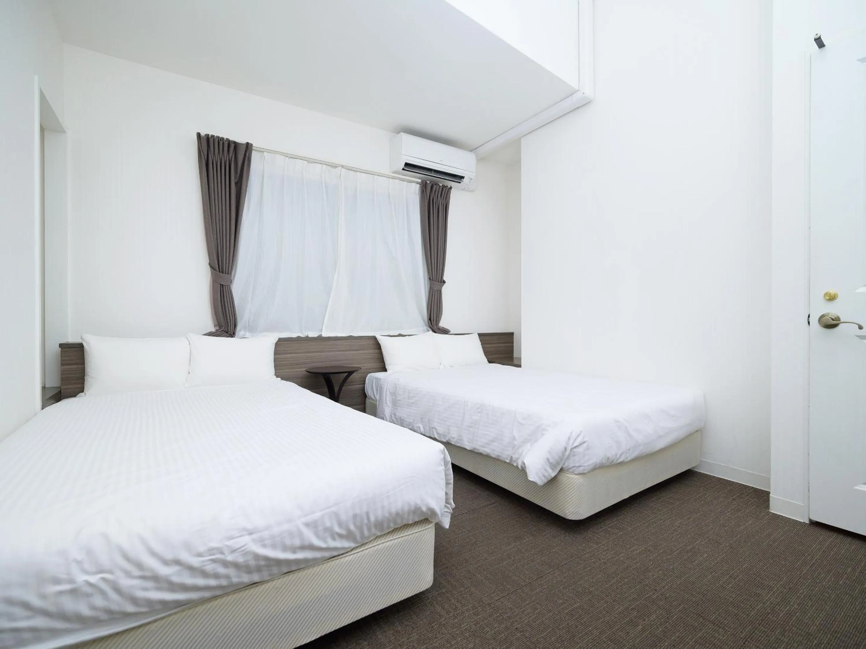 Photo of the whole room, Bed in HOTEL THE CUBE Naha Kokusai Street