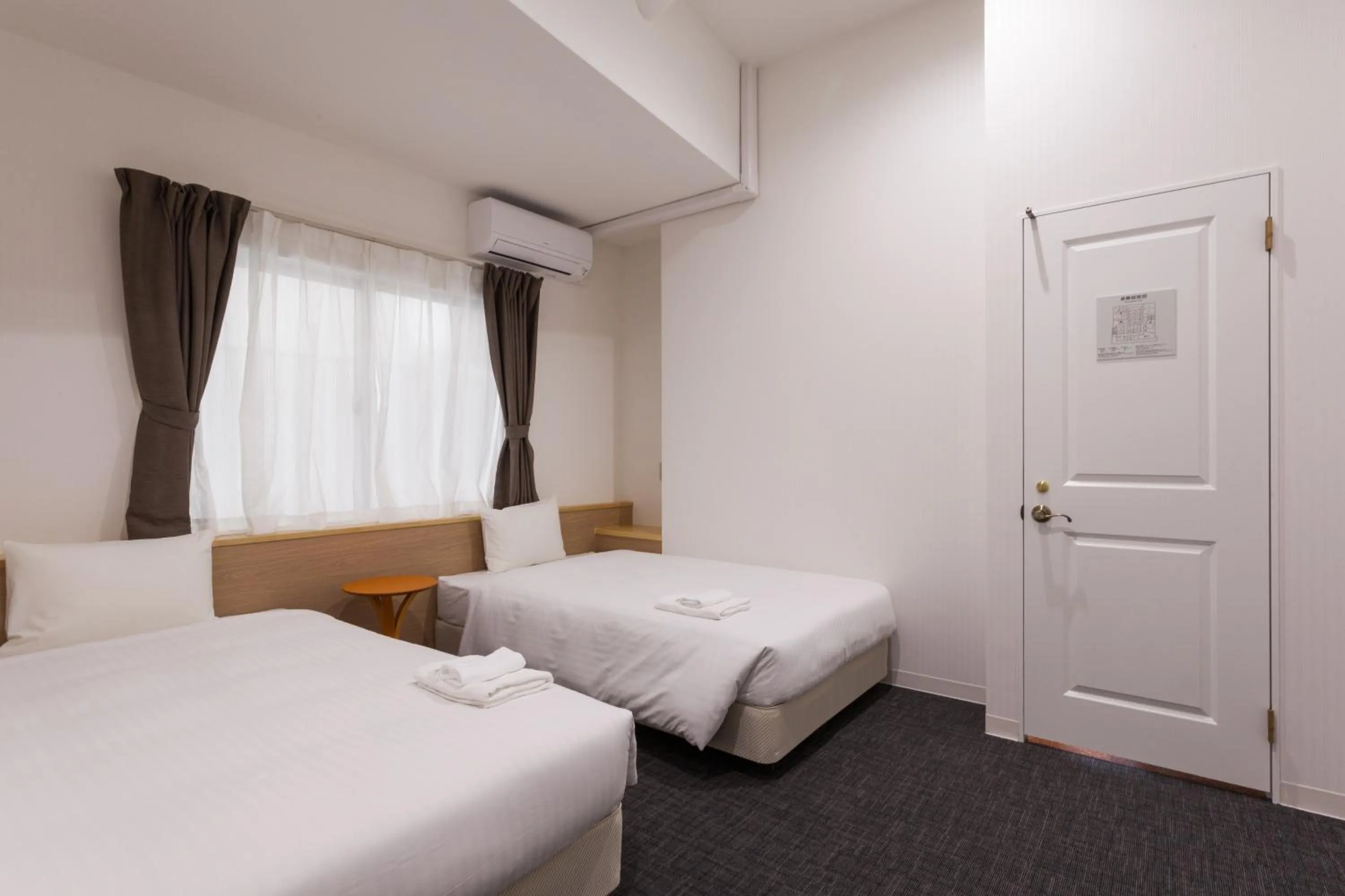 Photo of the whole room, Bed in HOTEL THE CUBE Naha Kokusai Street