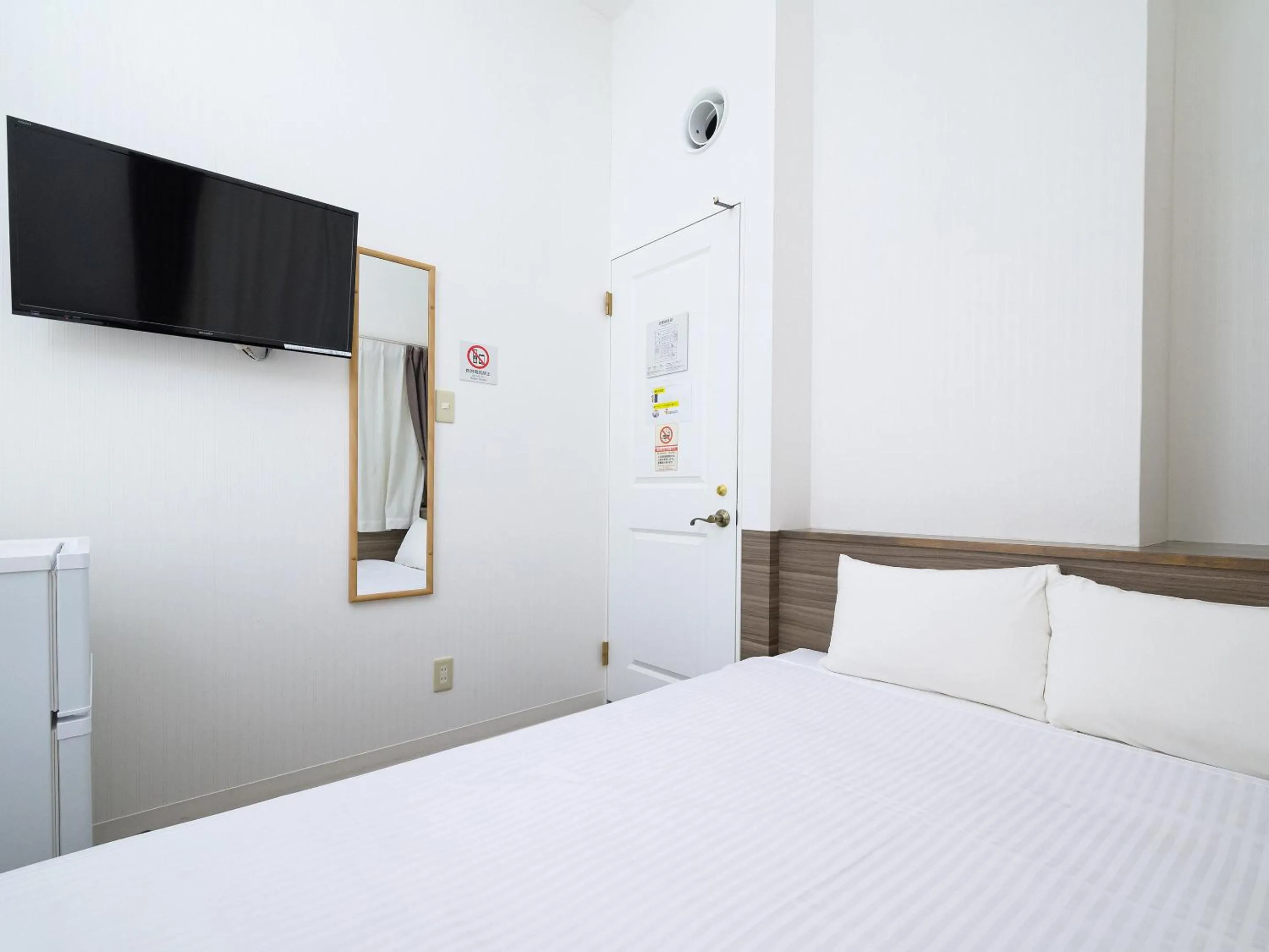 Photo of the whole room, Bed in HOTEL THE CUBE Naha Kokusai Street