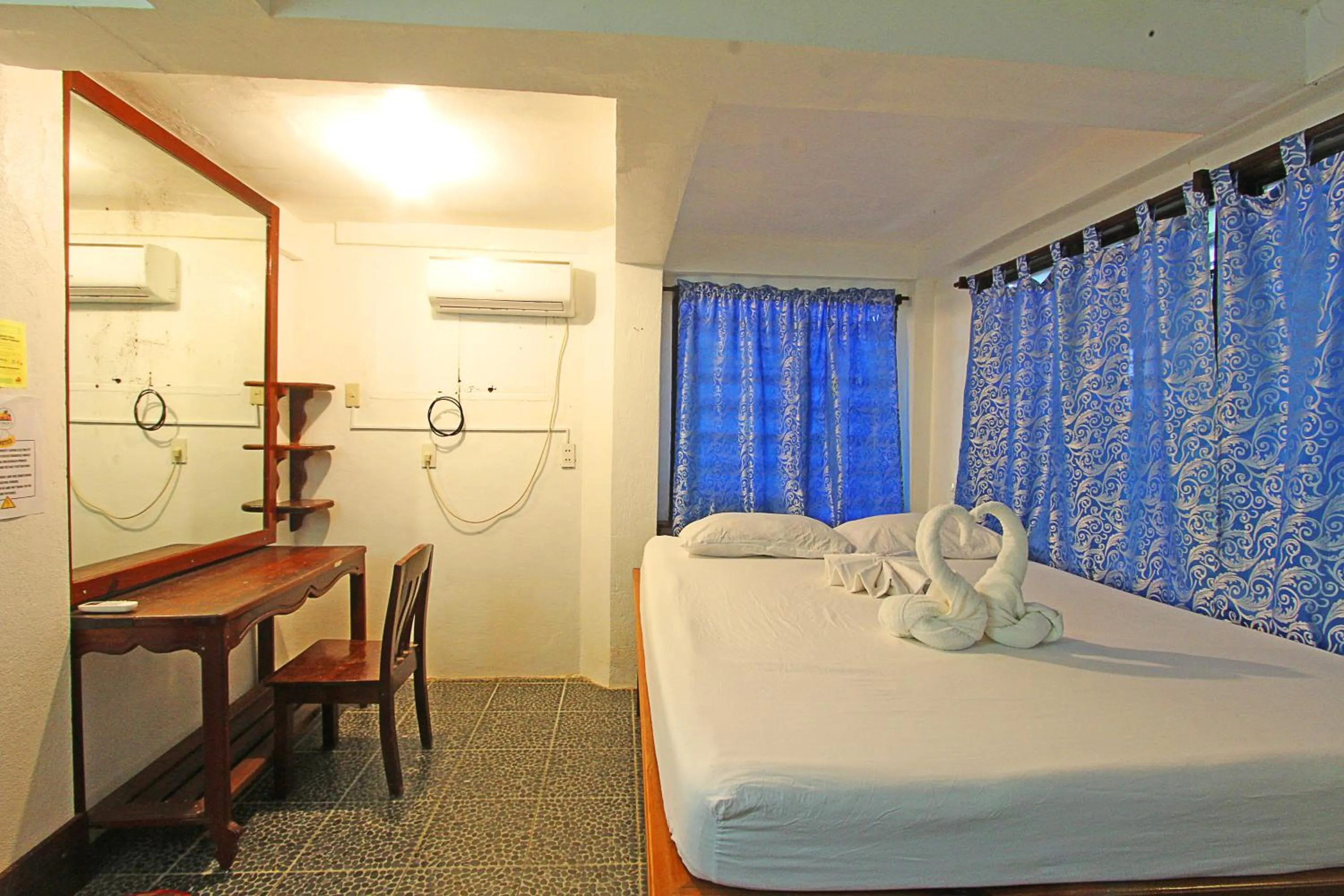 Bed in Patrick's on the Beach Resort