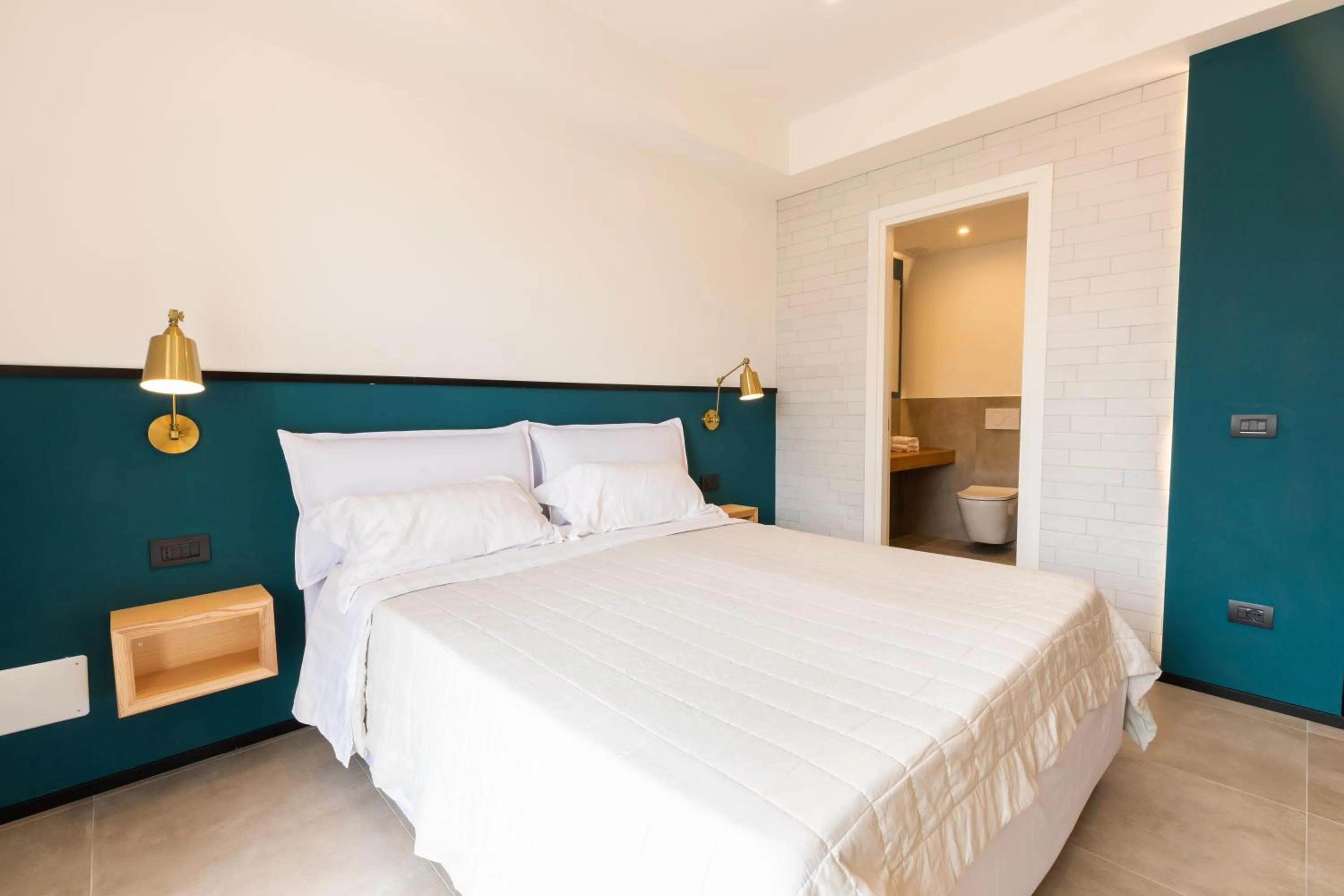 Bed in Antares Rooms and Suites