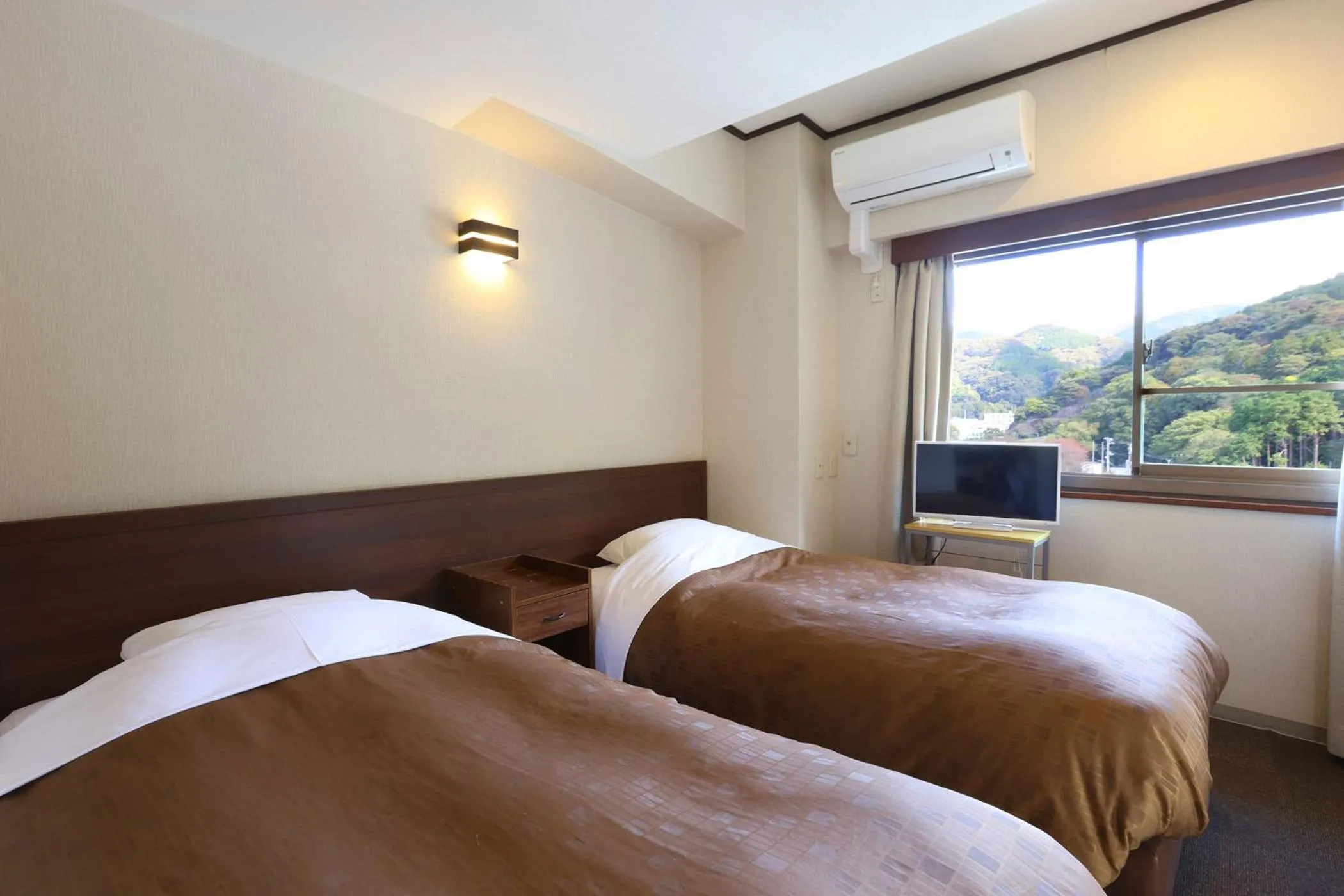 Bed in Ooedo Onsen Monogatari Toi Marine Hotel