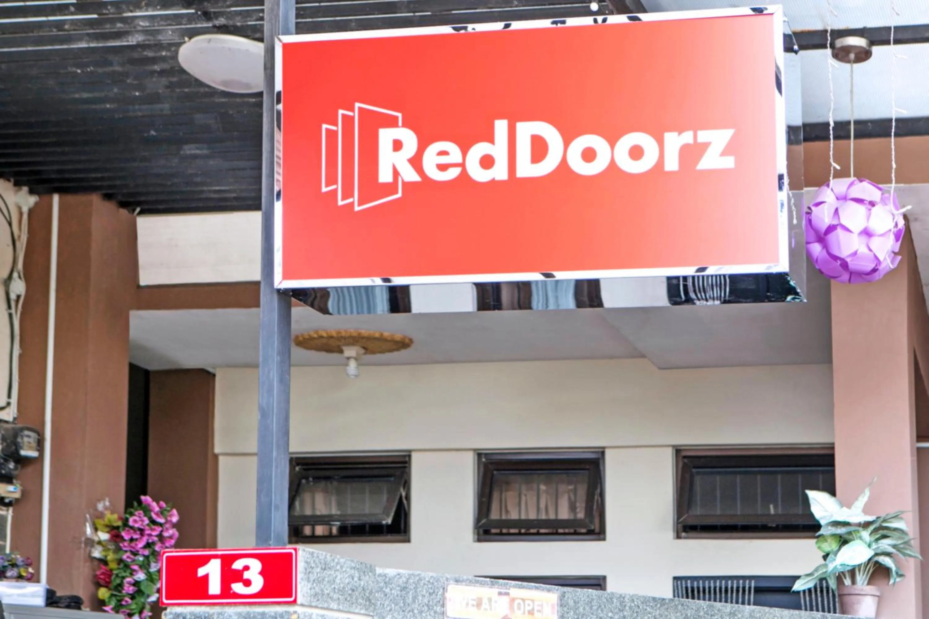 Property logo or sign in RedDoorz Plus near Isola UPI