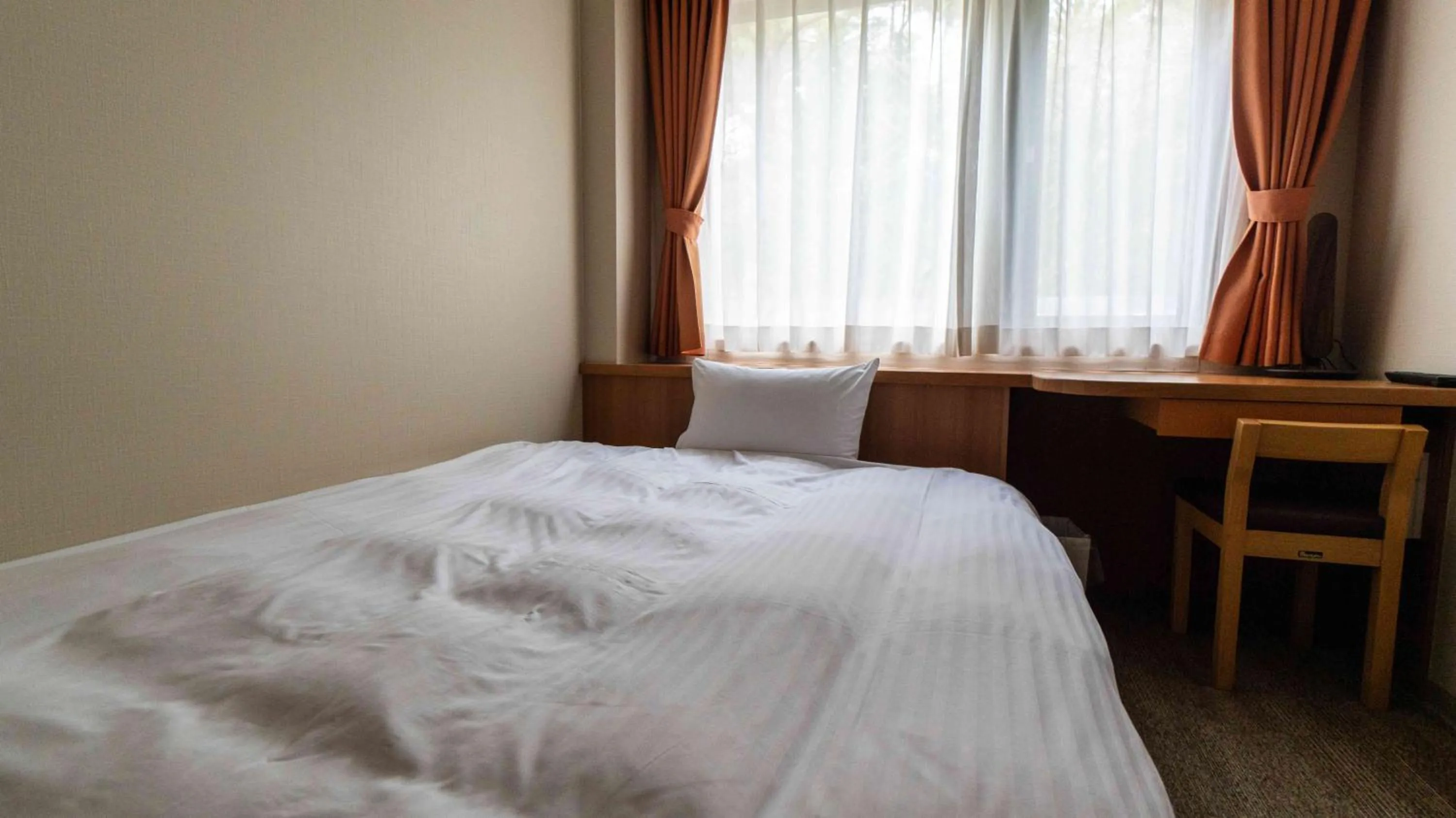 Bed in Motosu Phoenix Hotel