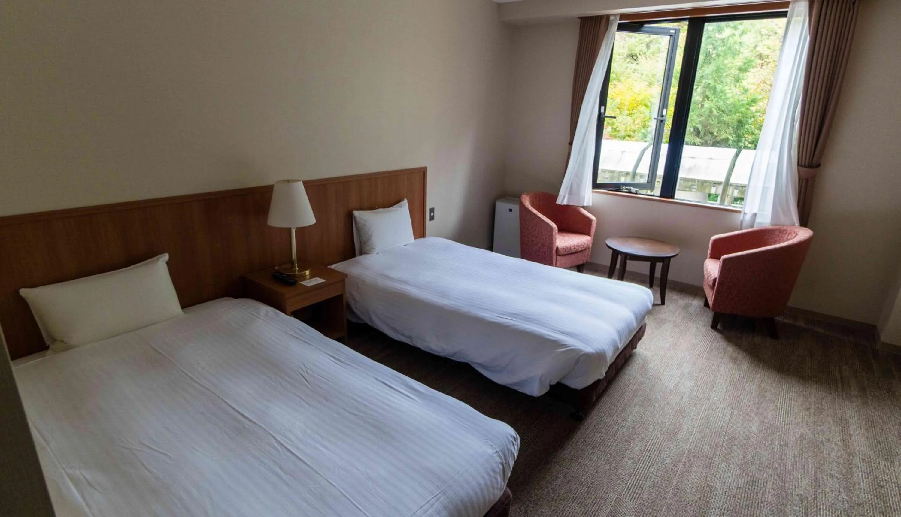 Bed in Motosu Phoenix Hotel