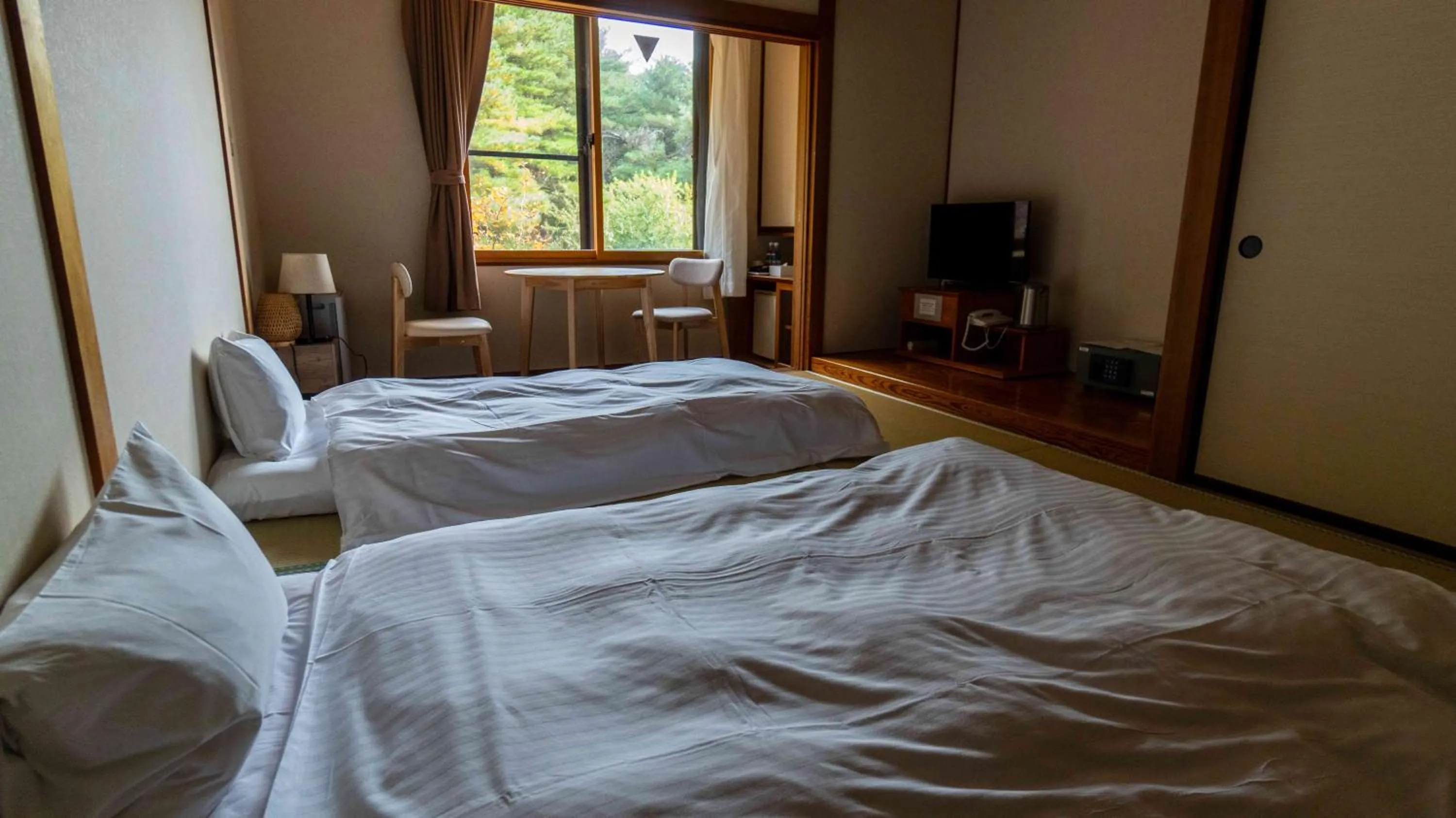 Bed in Motosu Phoenix Hotel