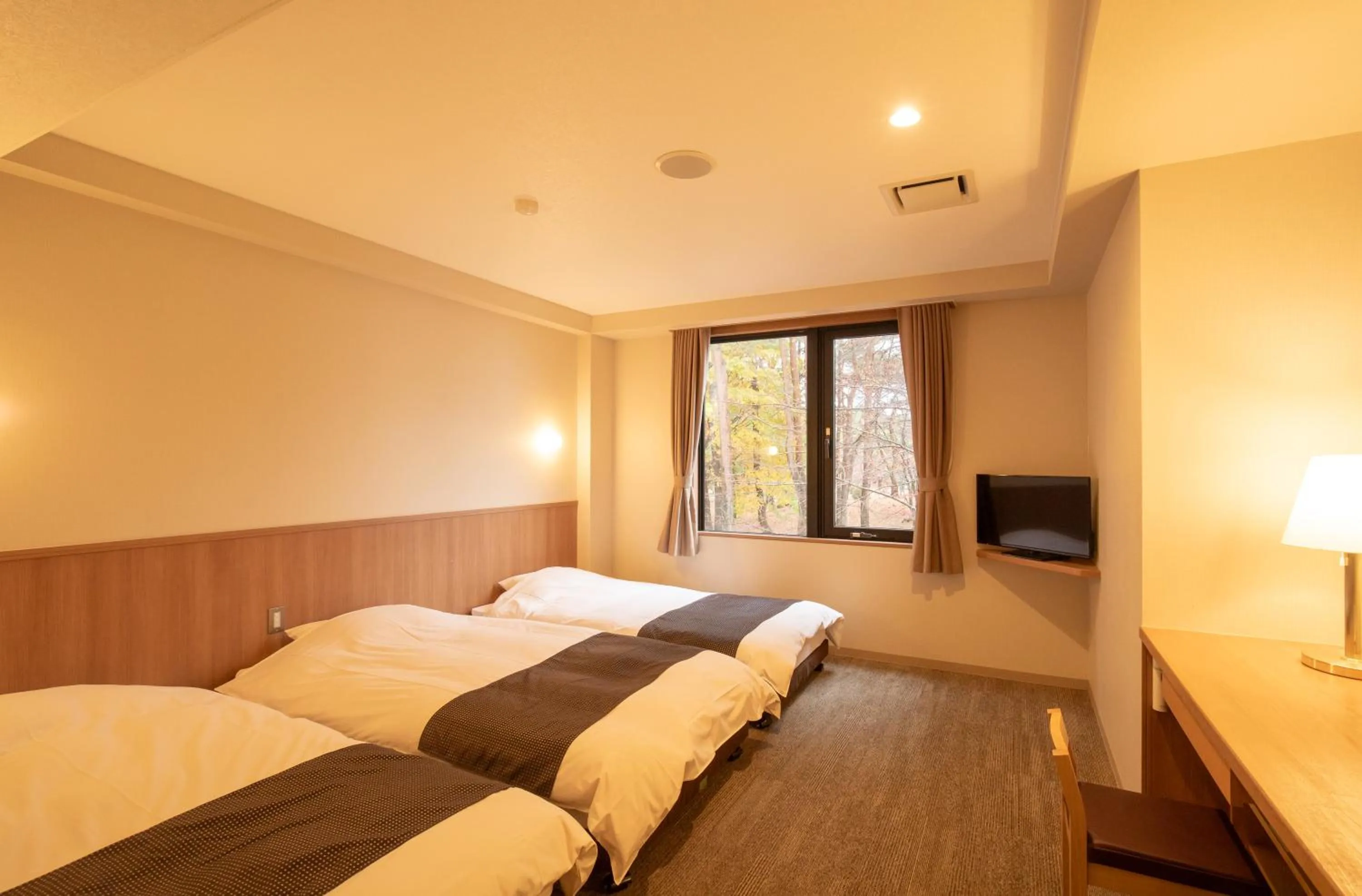 Bed in Motosu Phoenix Hotel