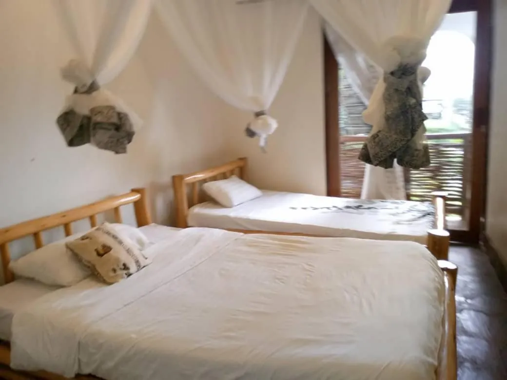 Bed in Lake Bunyonyi Rock Resort