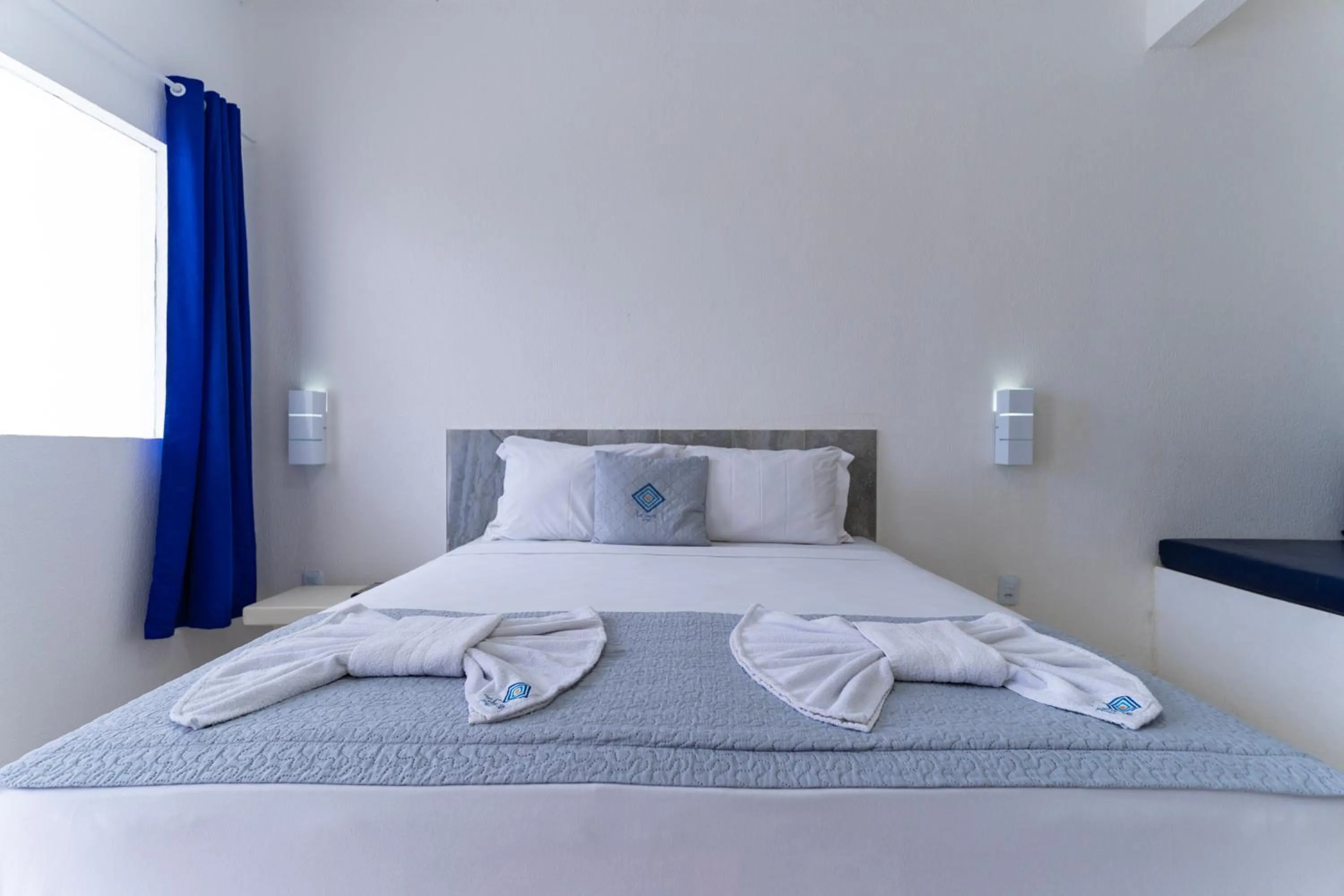 Bed in La Suite Praia Hotel