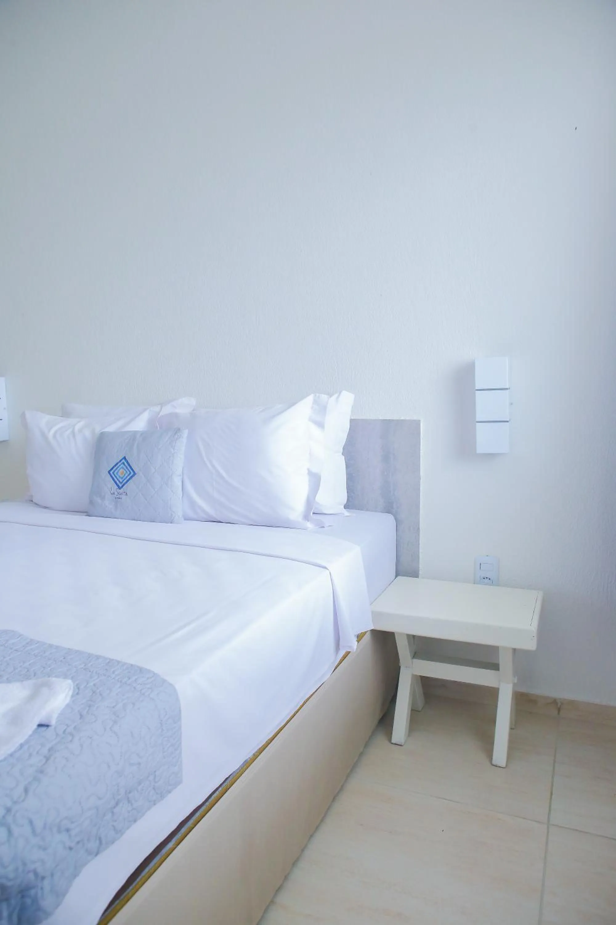 Bed in La Suite Praia Hotel