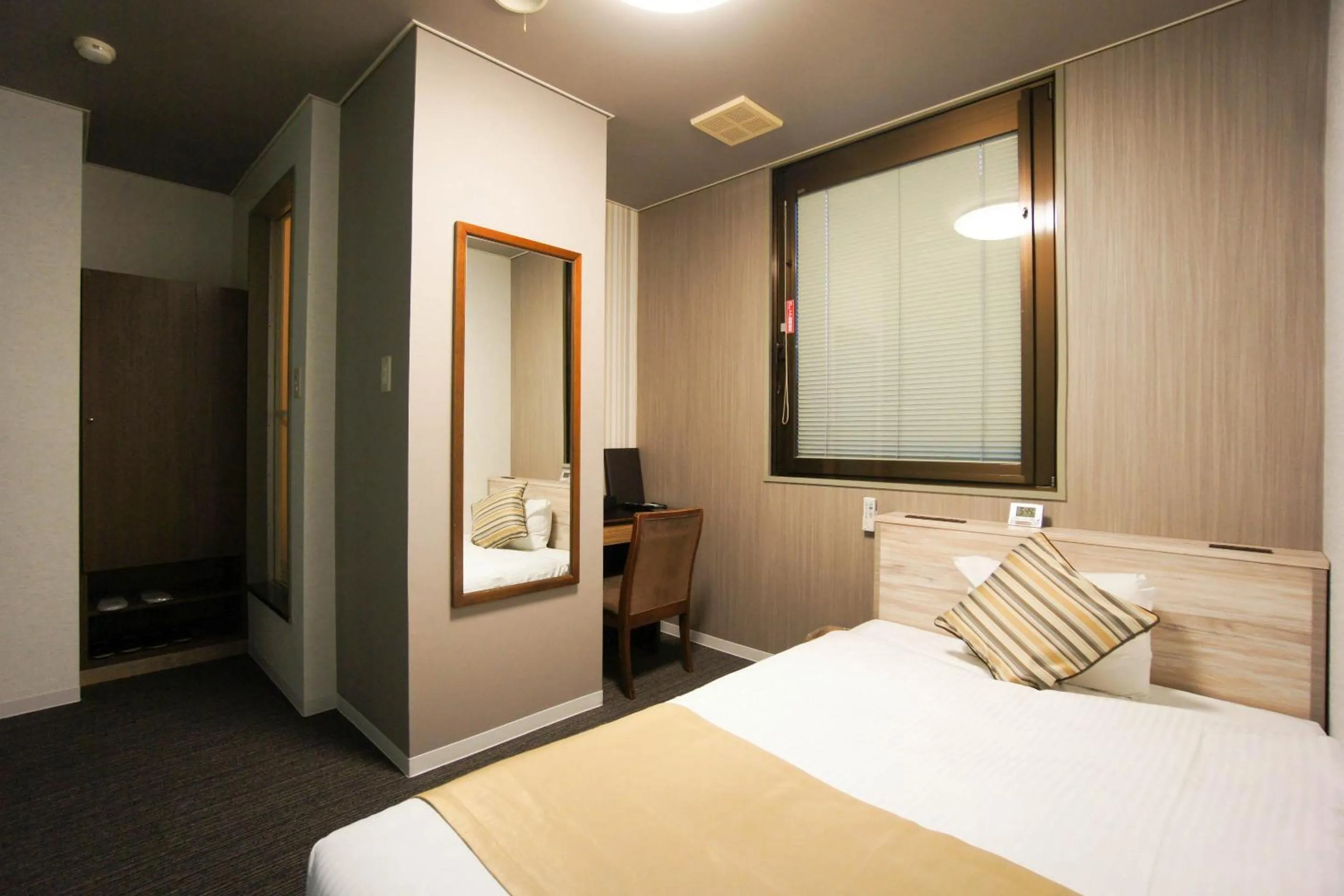 Bed in Hotel AreaOne Nobeoka