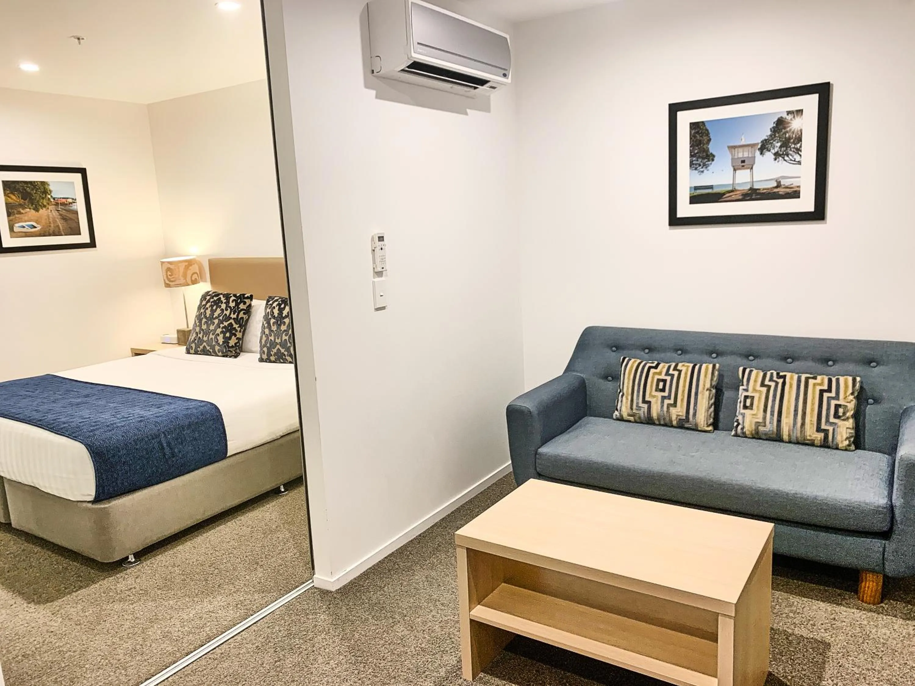 Living room, Bed in Ramada Suites by Wyndham Albany