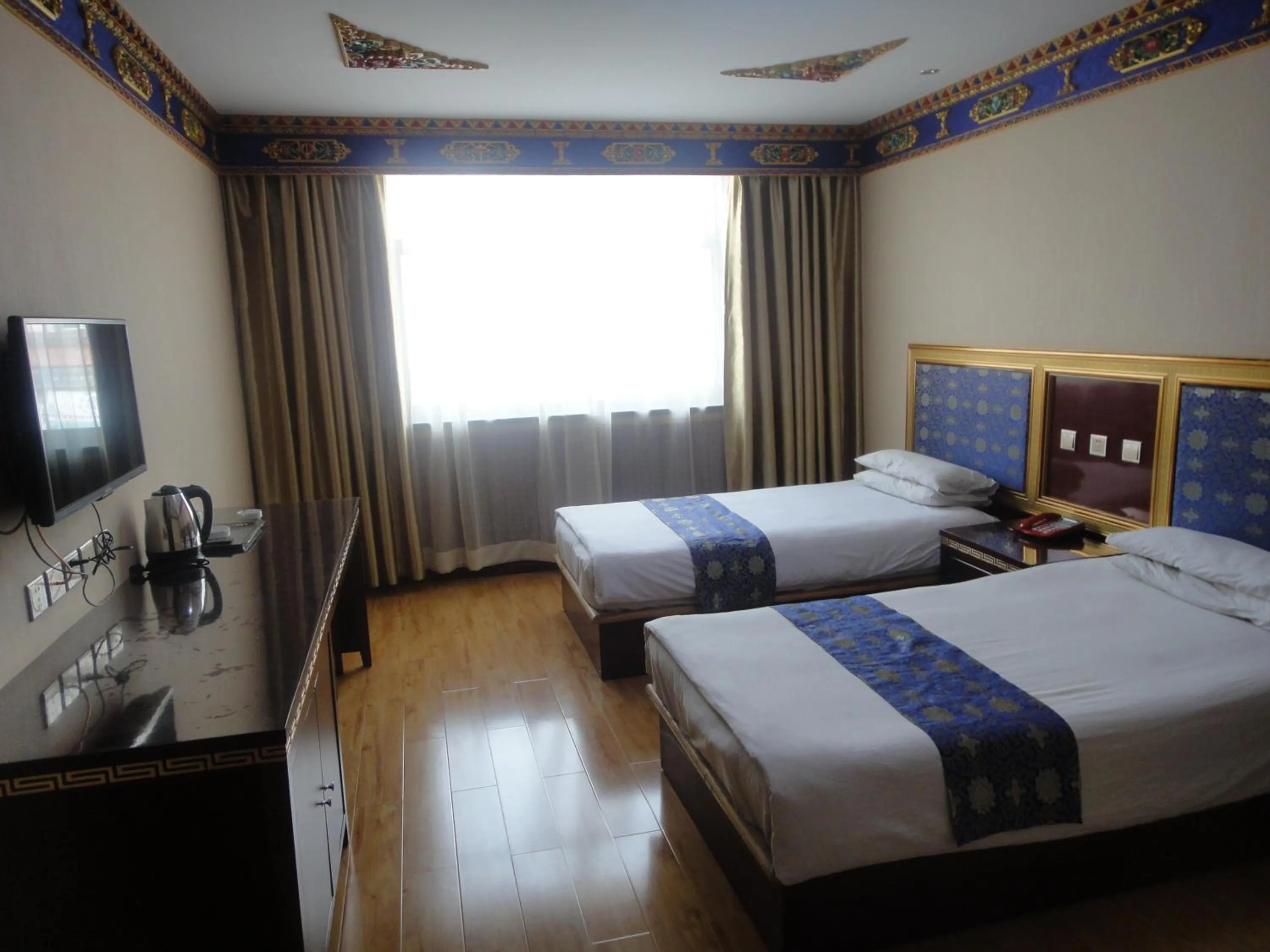 Photo of the whole room, Bed in Overseas Tibetan Hotel