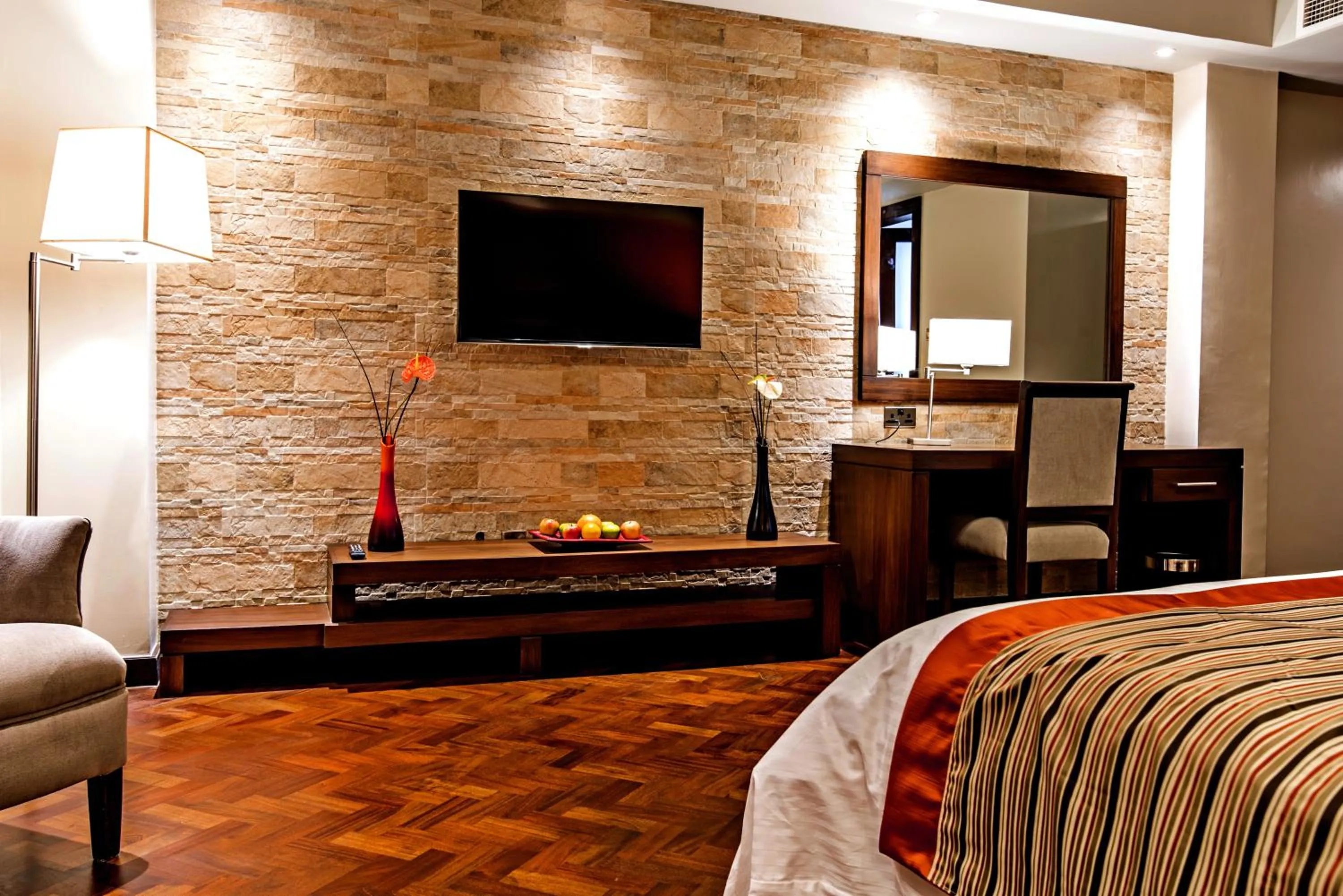 Bed, TV/Entertainment Center in Magna Hotel and Suites