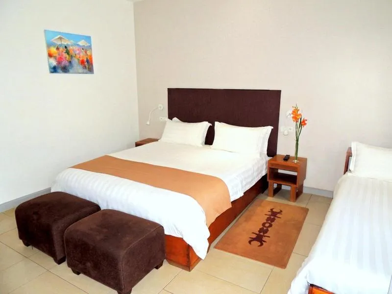 Bed in Plumeria Hotel