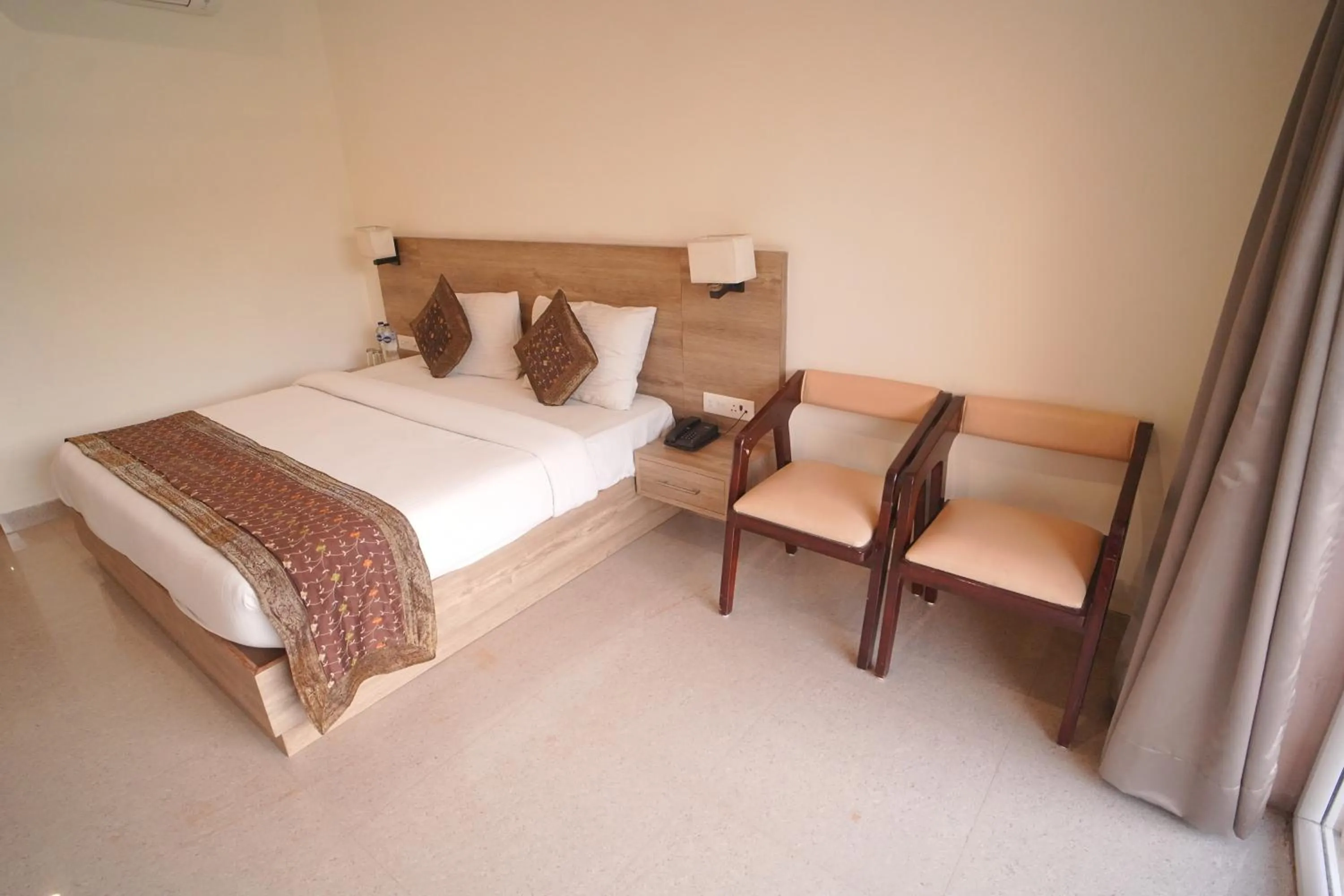 Bed in Dhawala Resort By Aamod