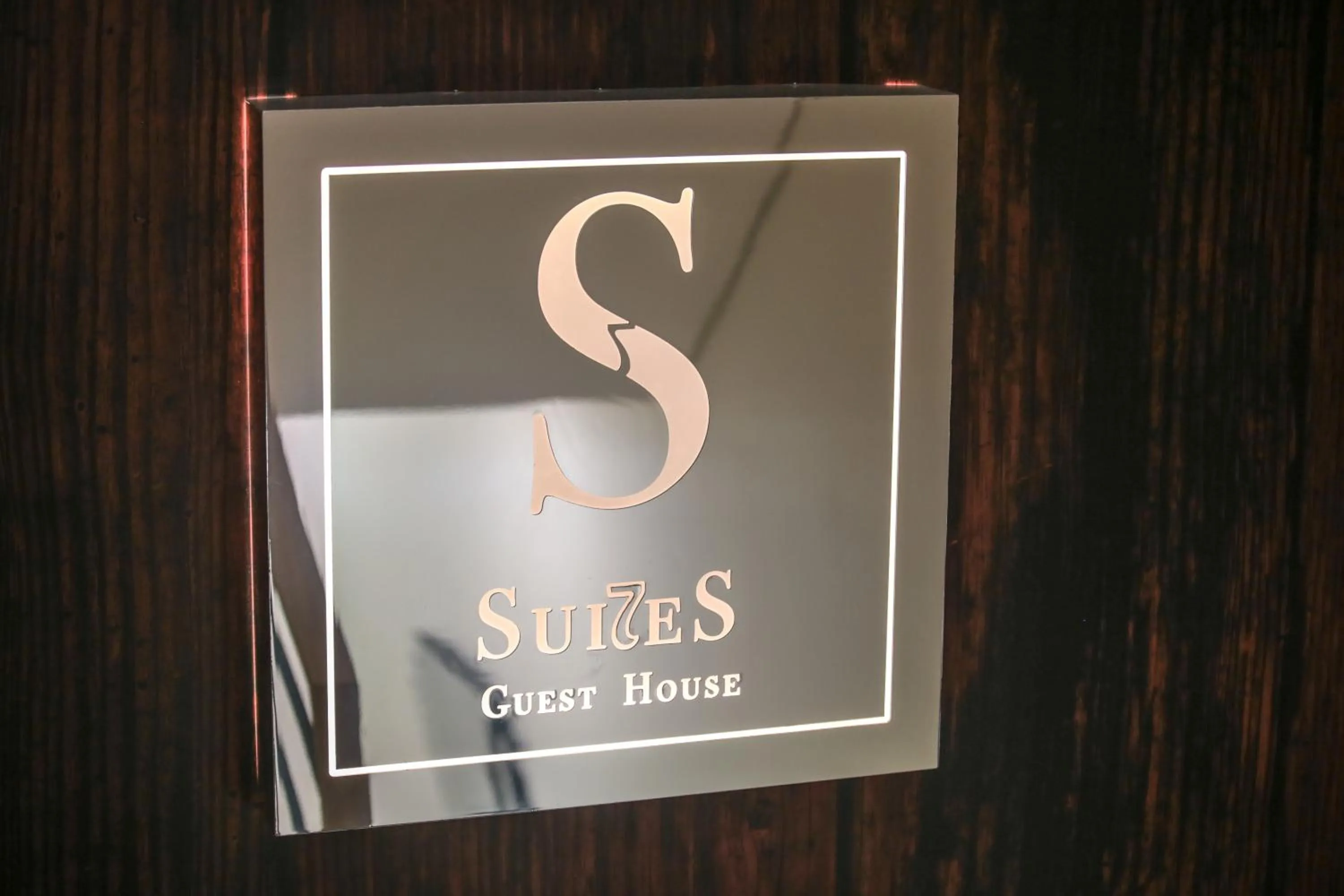 Property logo or sign in Suites Guest House