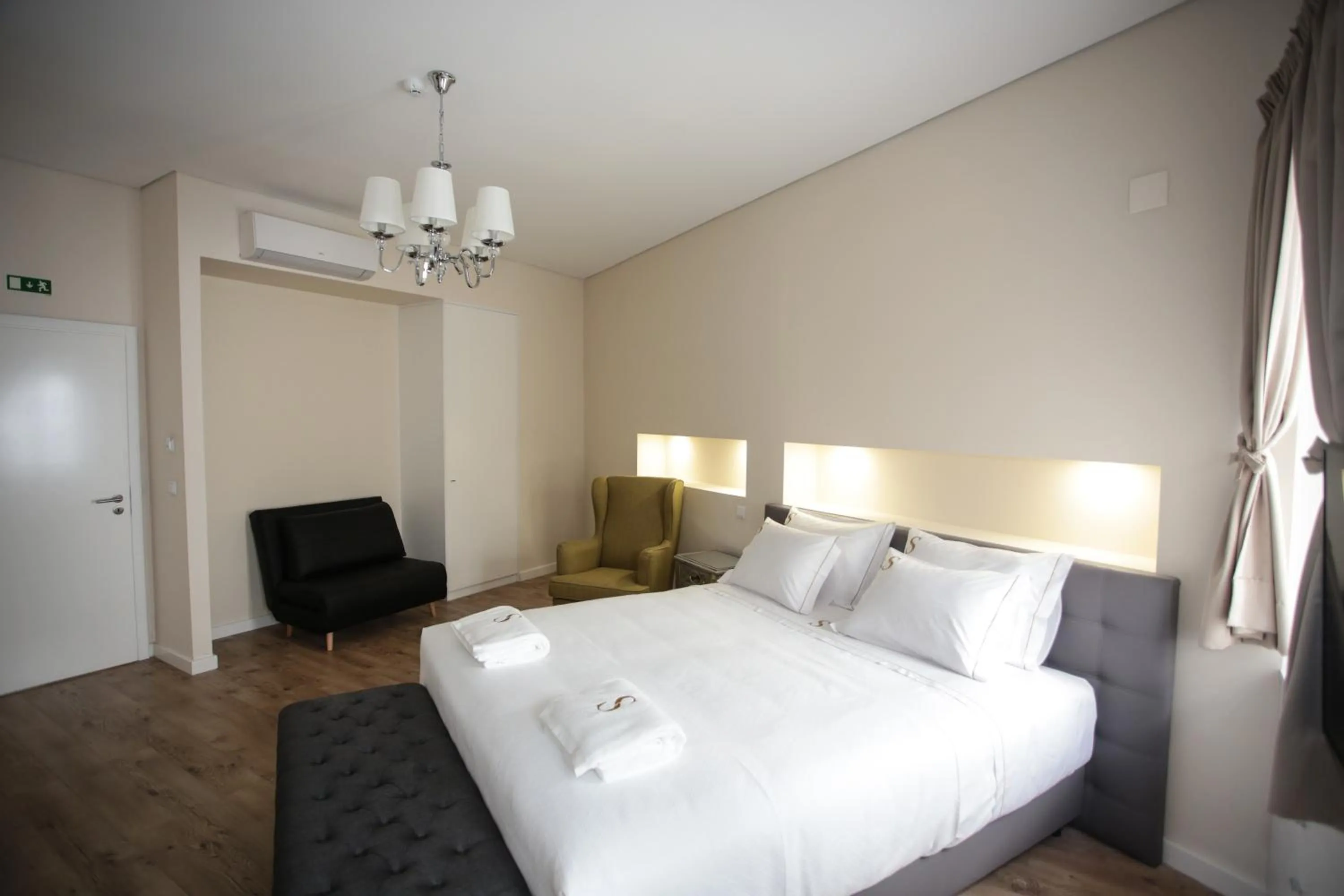 Living room, Bed in Suites Guest House