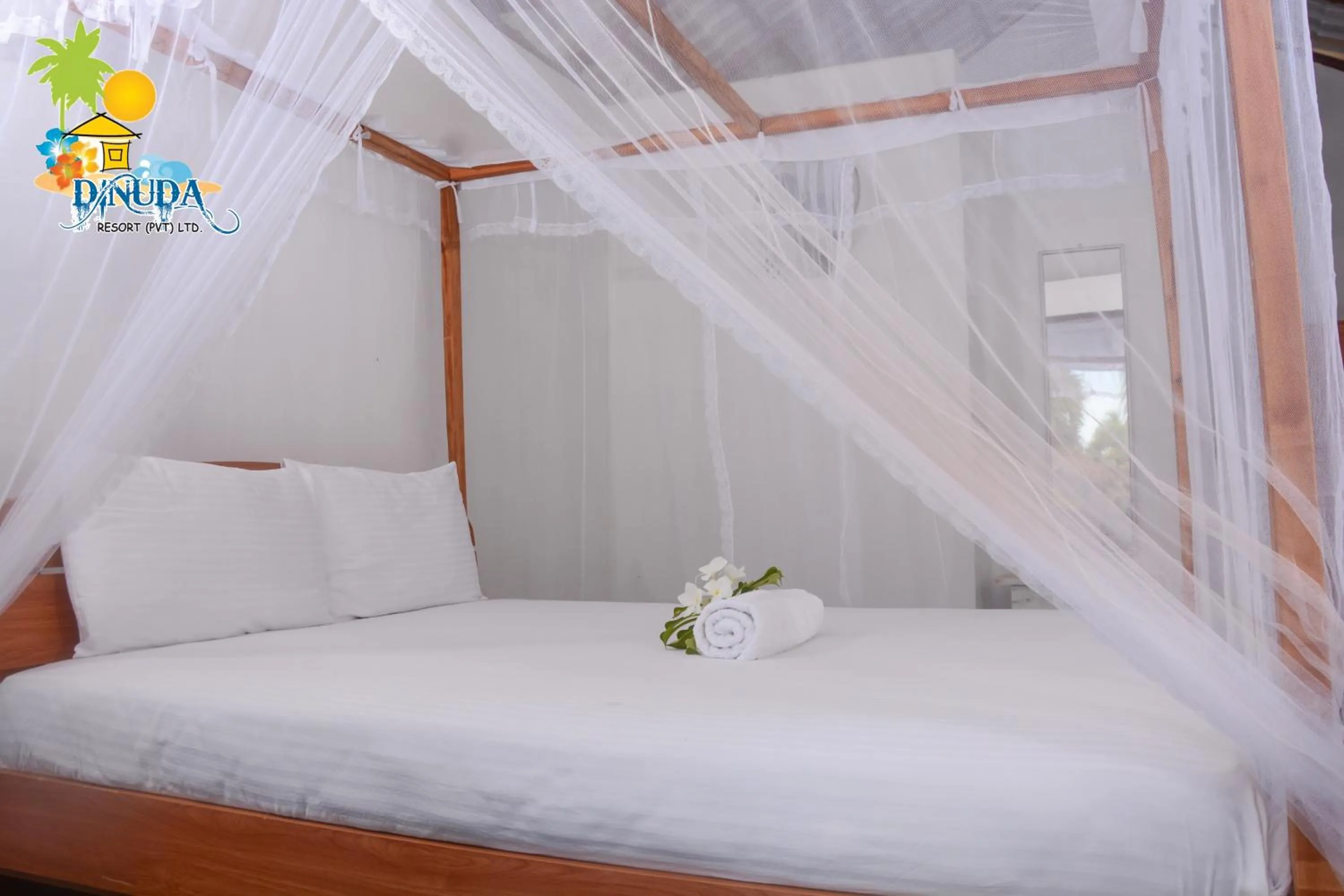 Bed in Dinuda Lagoon Hotel