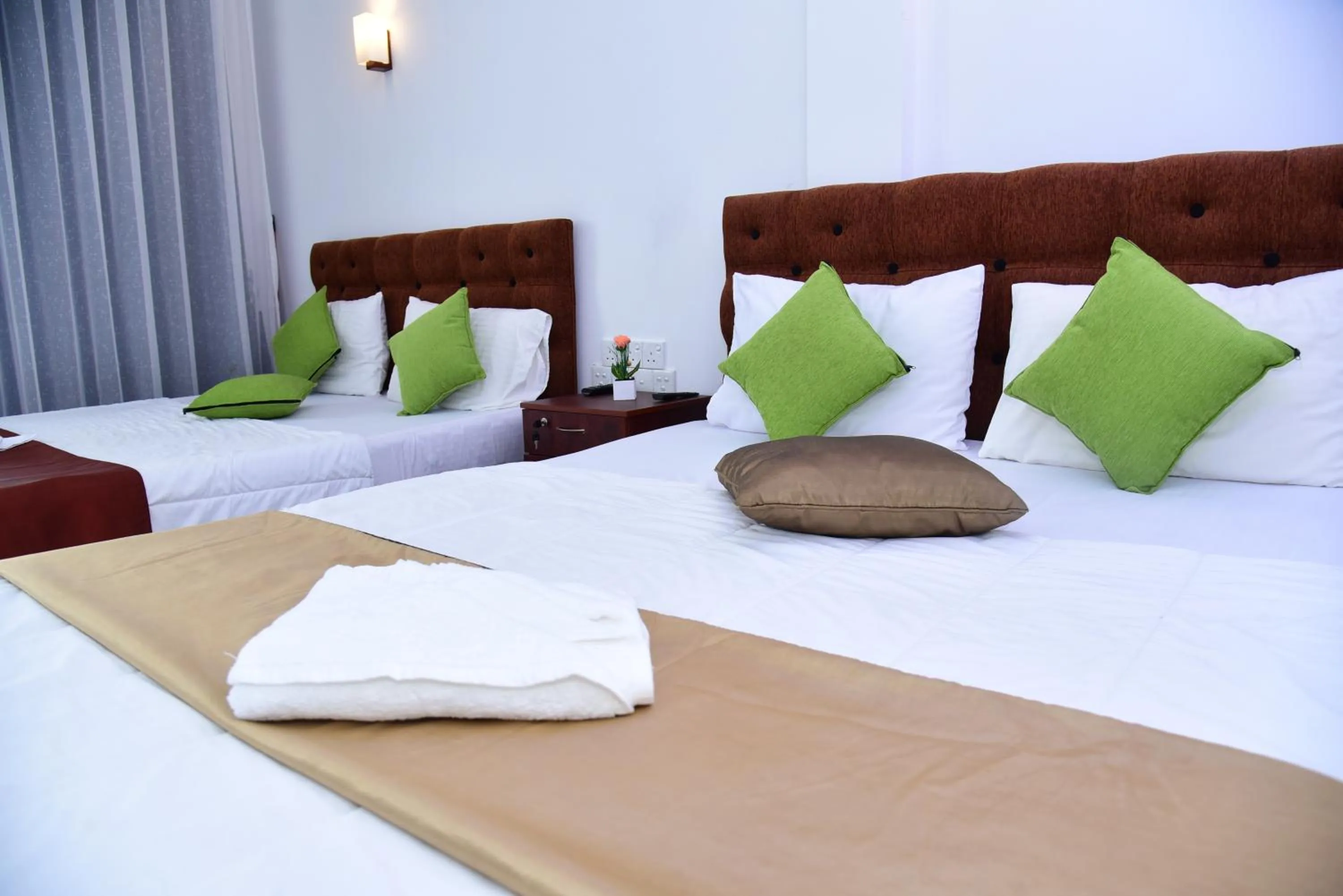 Bed in Dinuda Lagoon Hotel