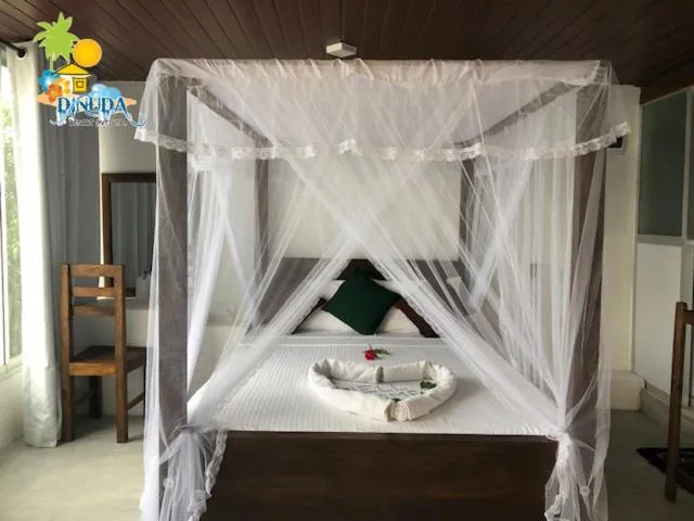 Bed in Dinuda Lagoon Hotel