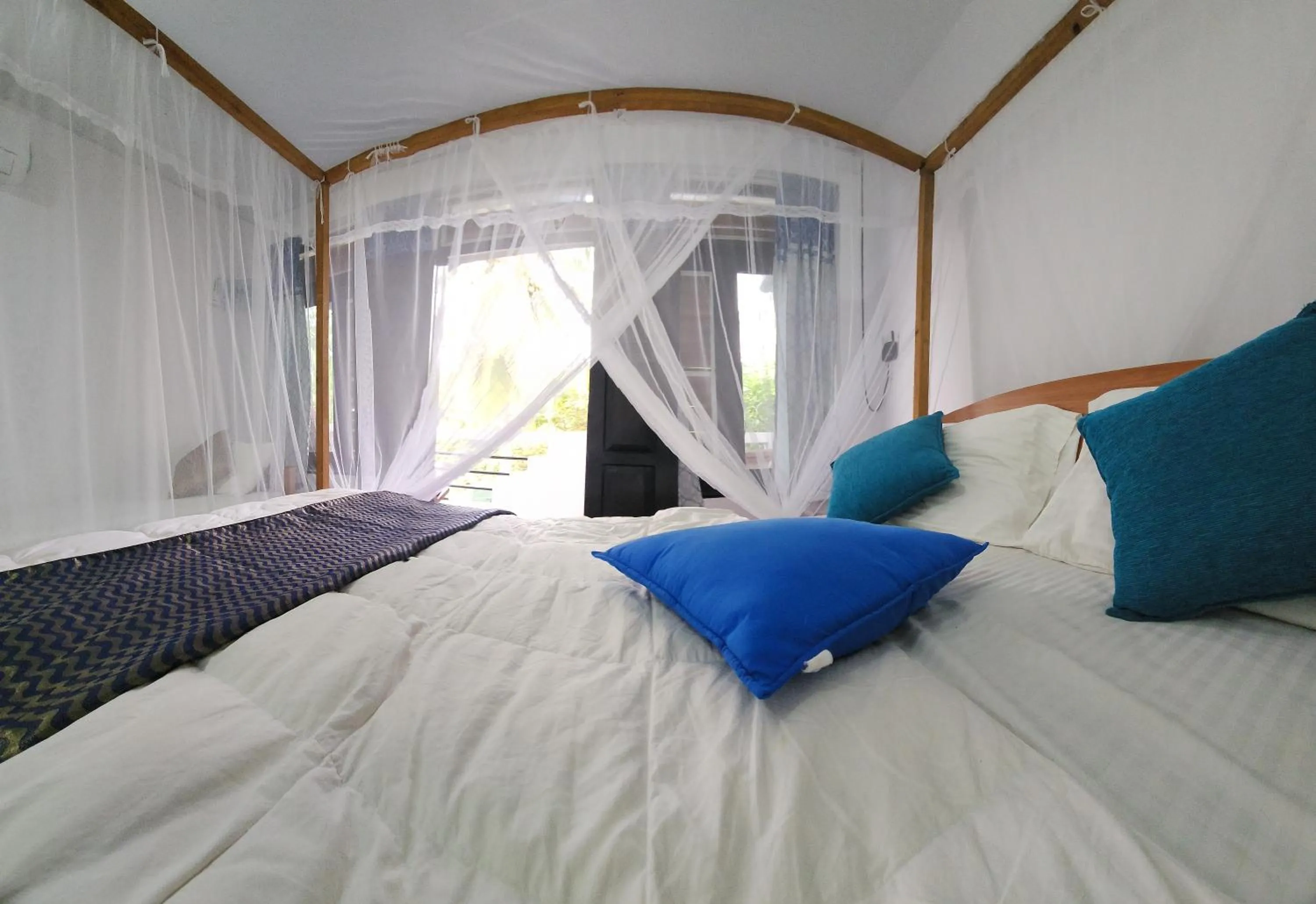 Bed in Dinuda Lagoon Hotel