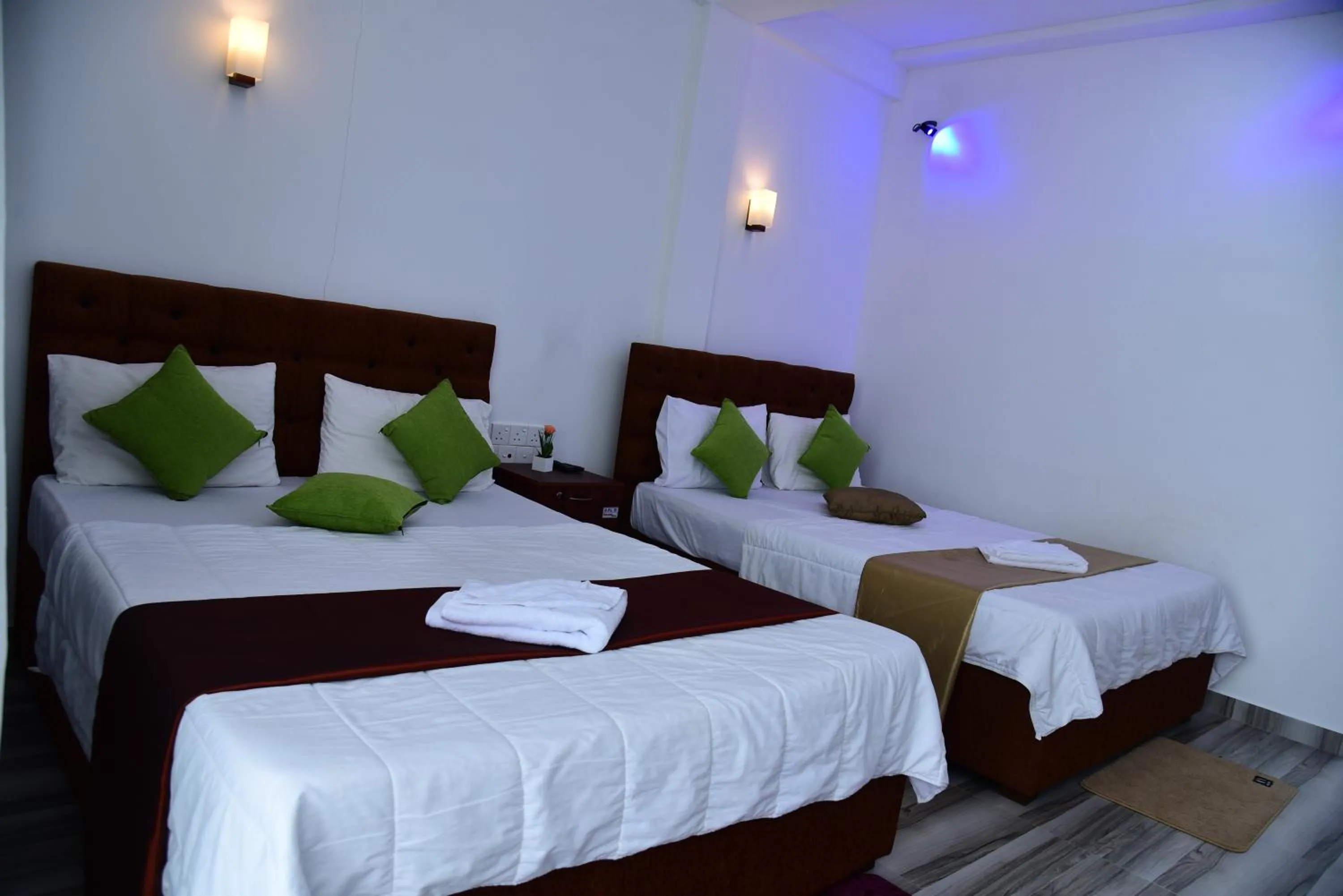 Bed in Dinuda Lagoon Hotel