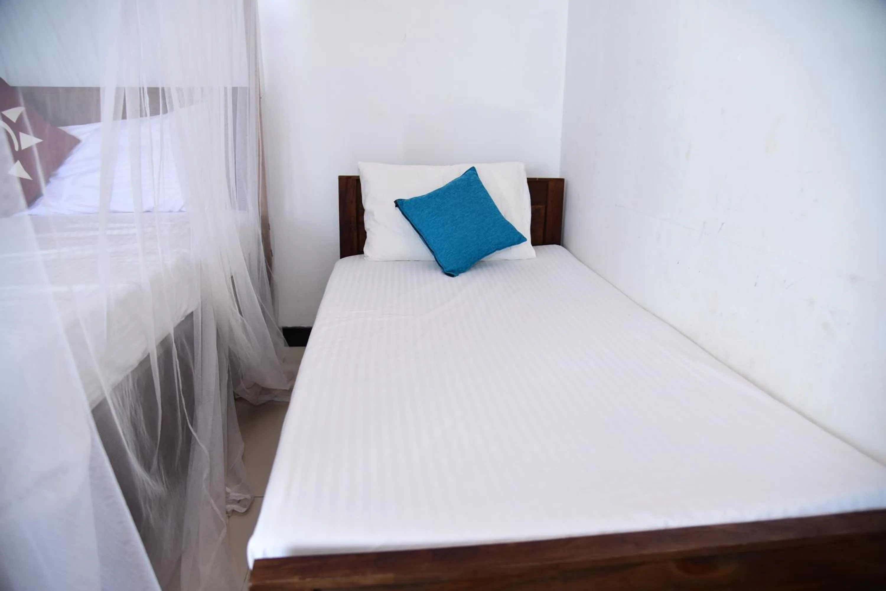 Bed in Dinuda Lagoon Hotel