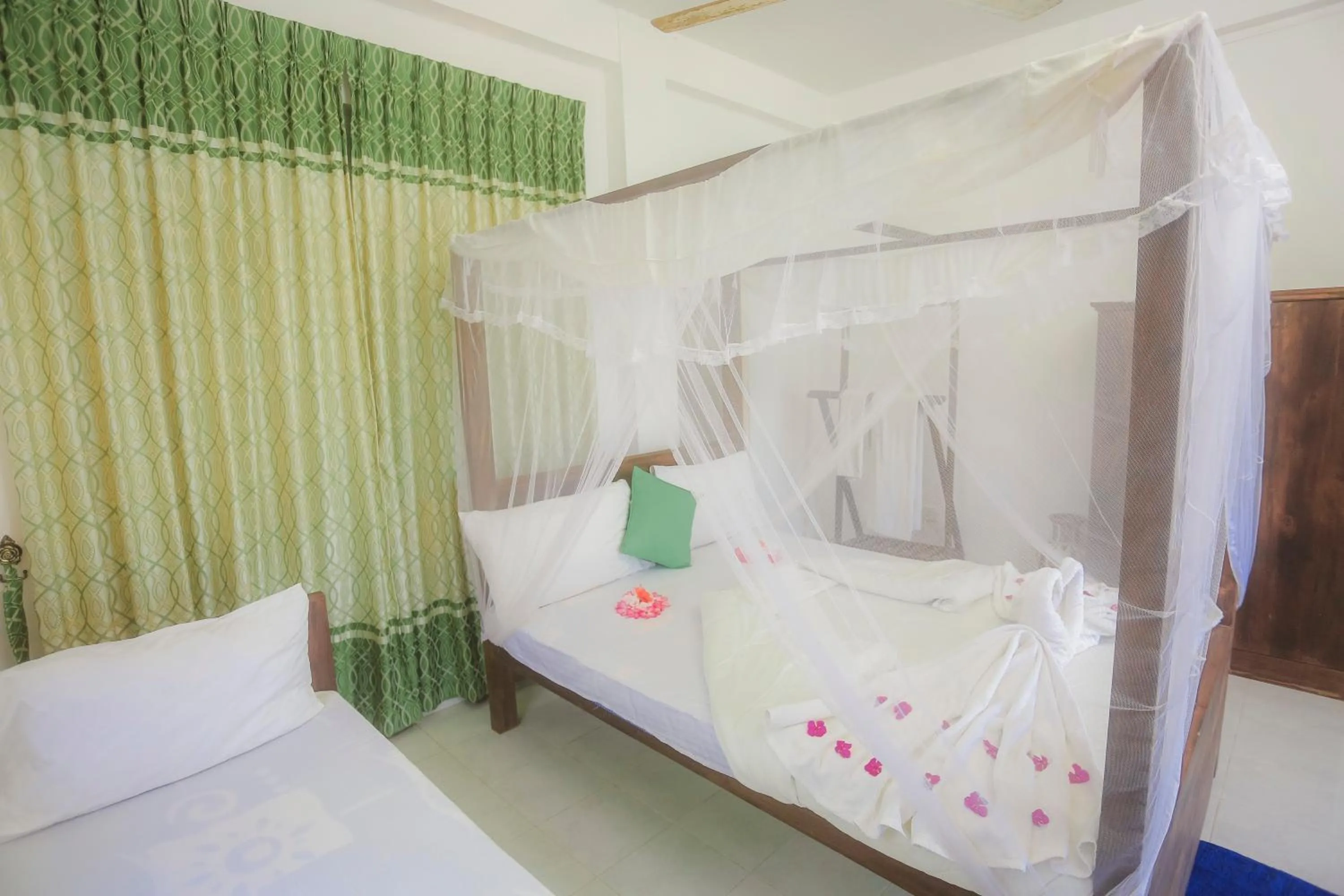 Bed in Dinuda Lagoon Hotel