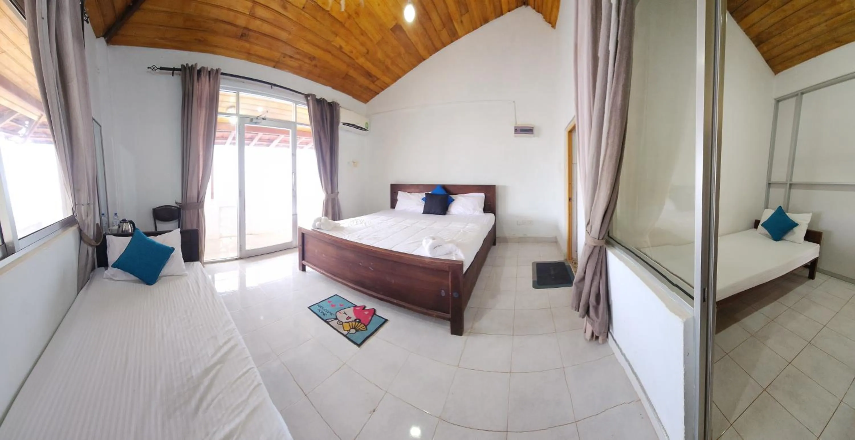 Bed in Dinuda Lagoon Hotel