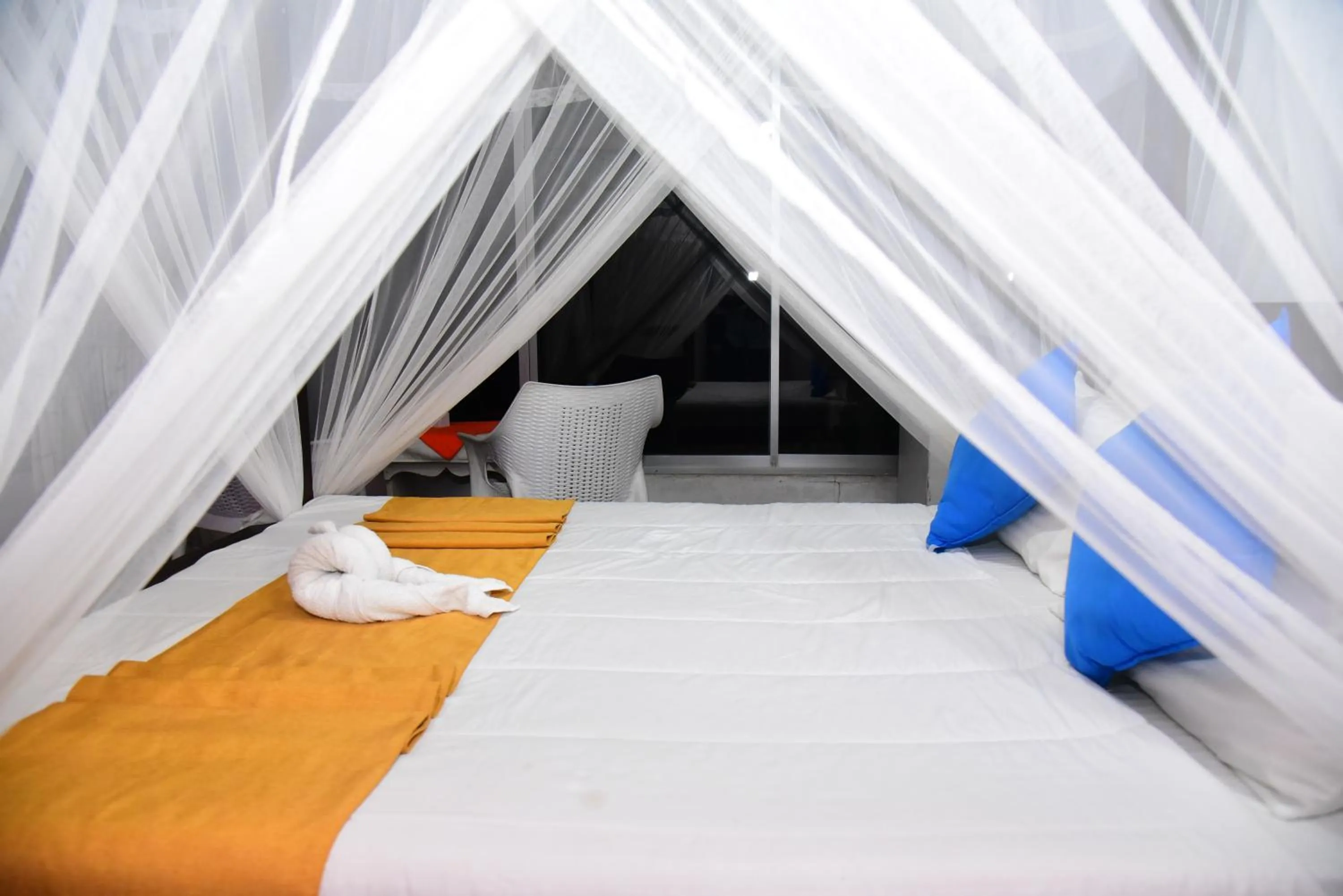 Bed in Dinuda Lagoon Hotel