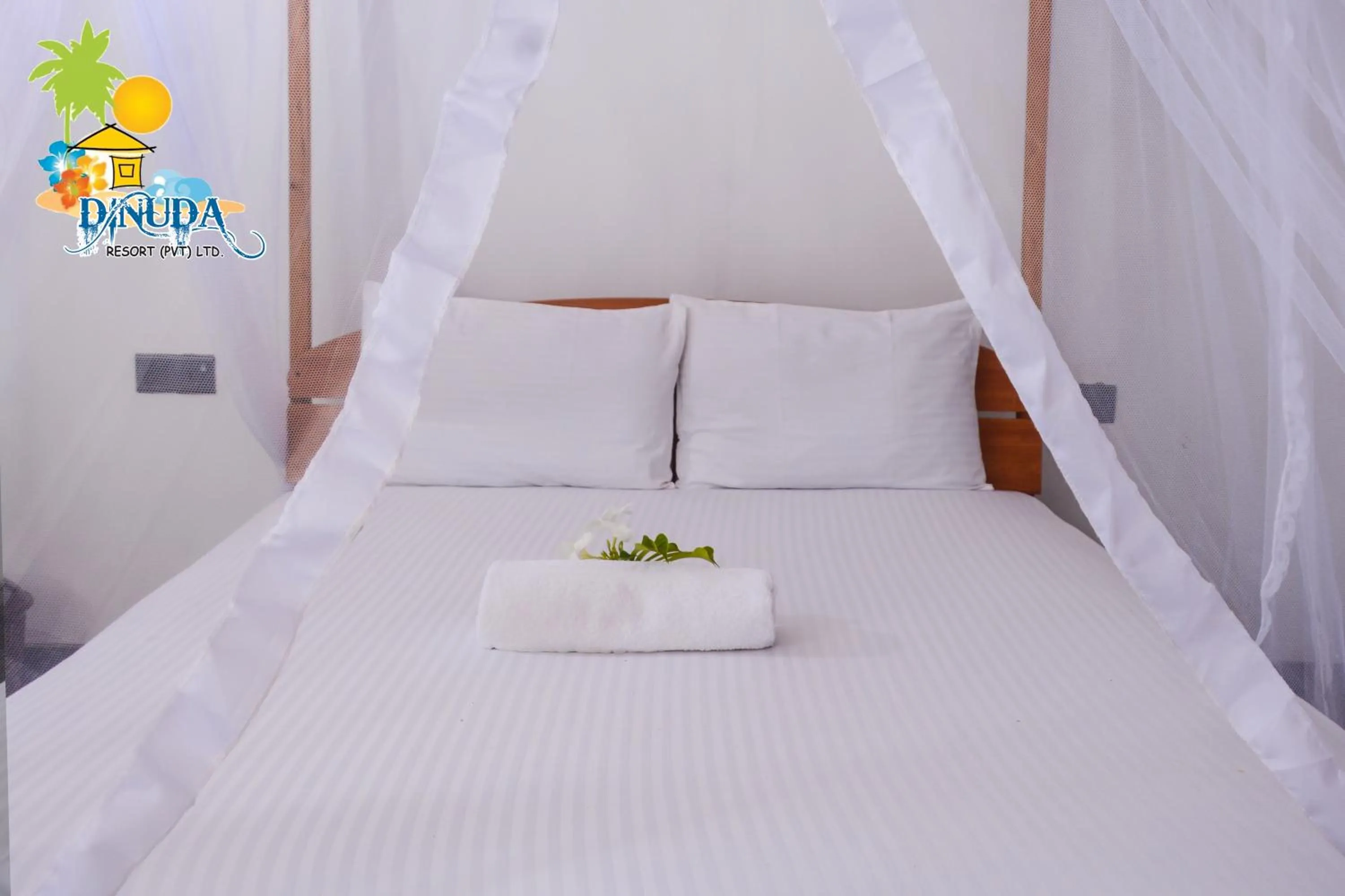 Bed in Dinuda Lagoon Hotel