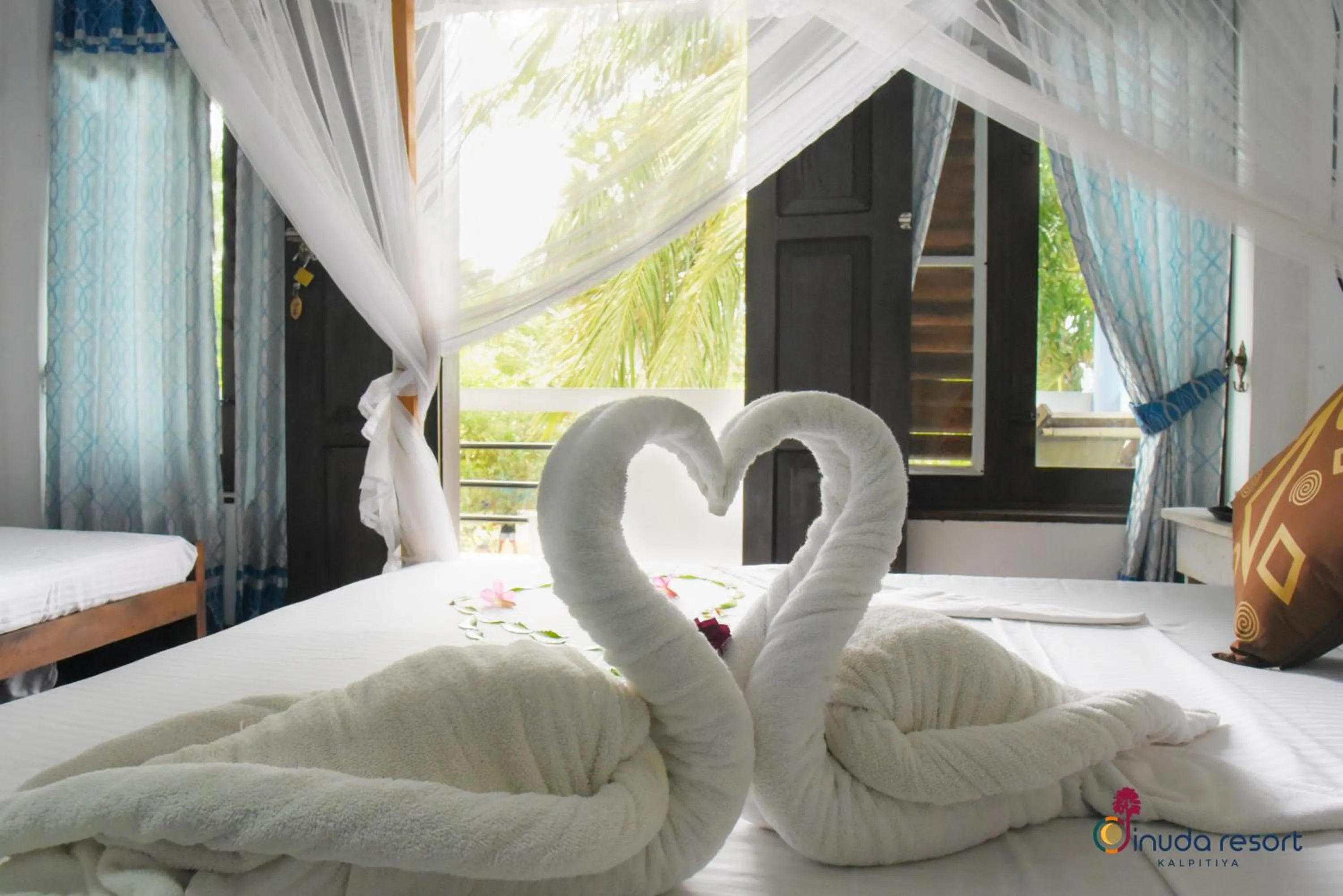 Bed in Dinuda Lagoon Hotel