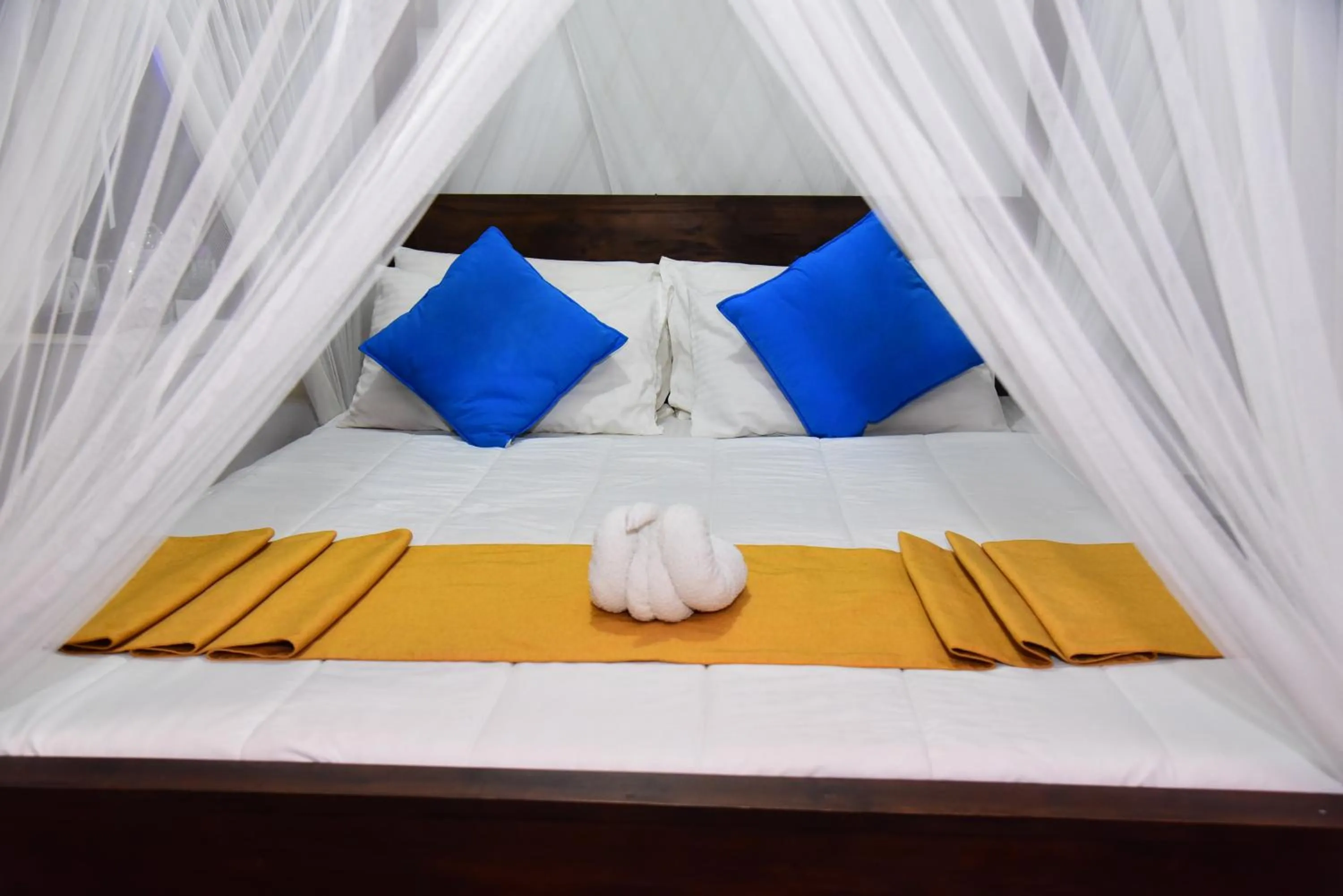 Bed in Dinuda Lagoon Hotel