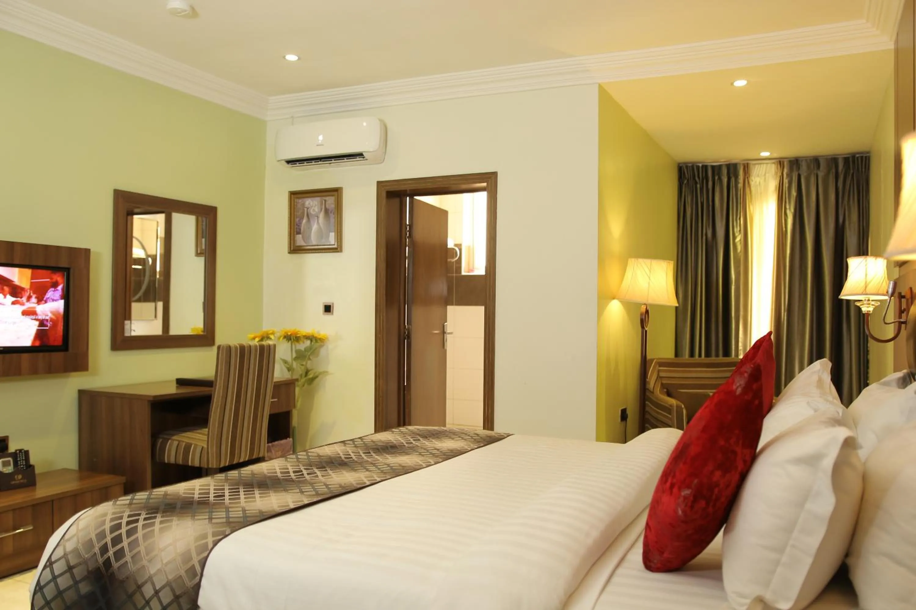 Bed in Grand Pela Hotel & Suites