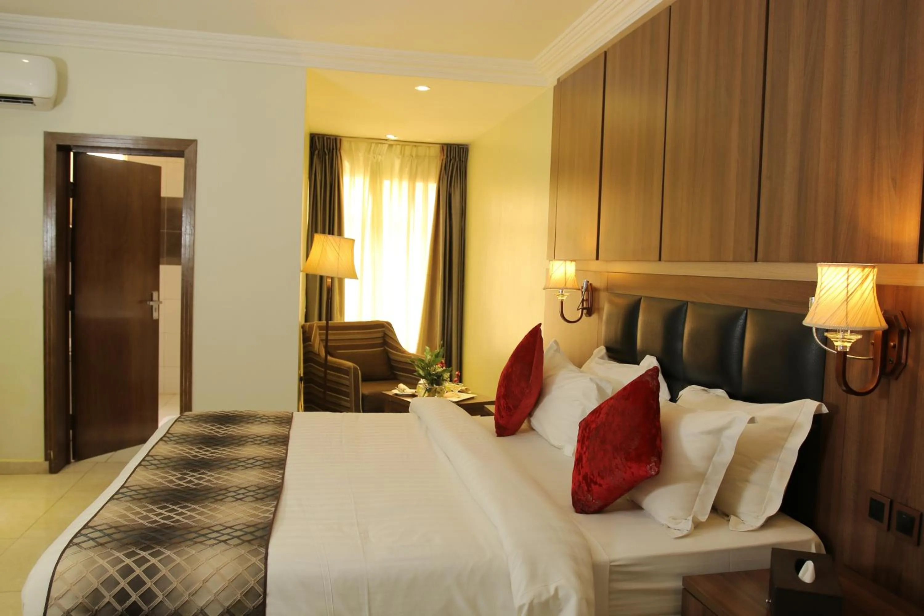 Bed in Grand Pela Hotel & Suites
