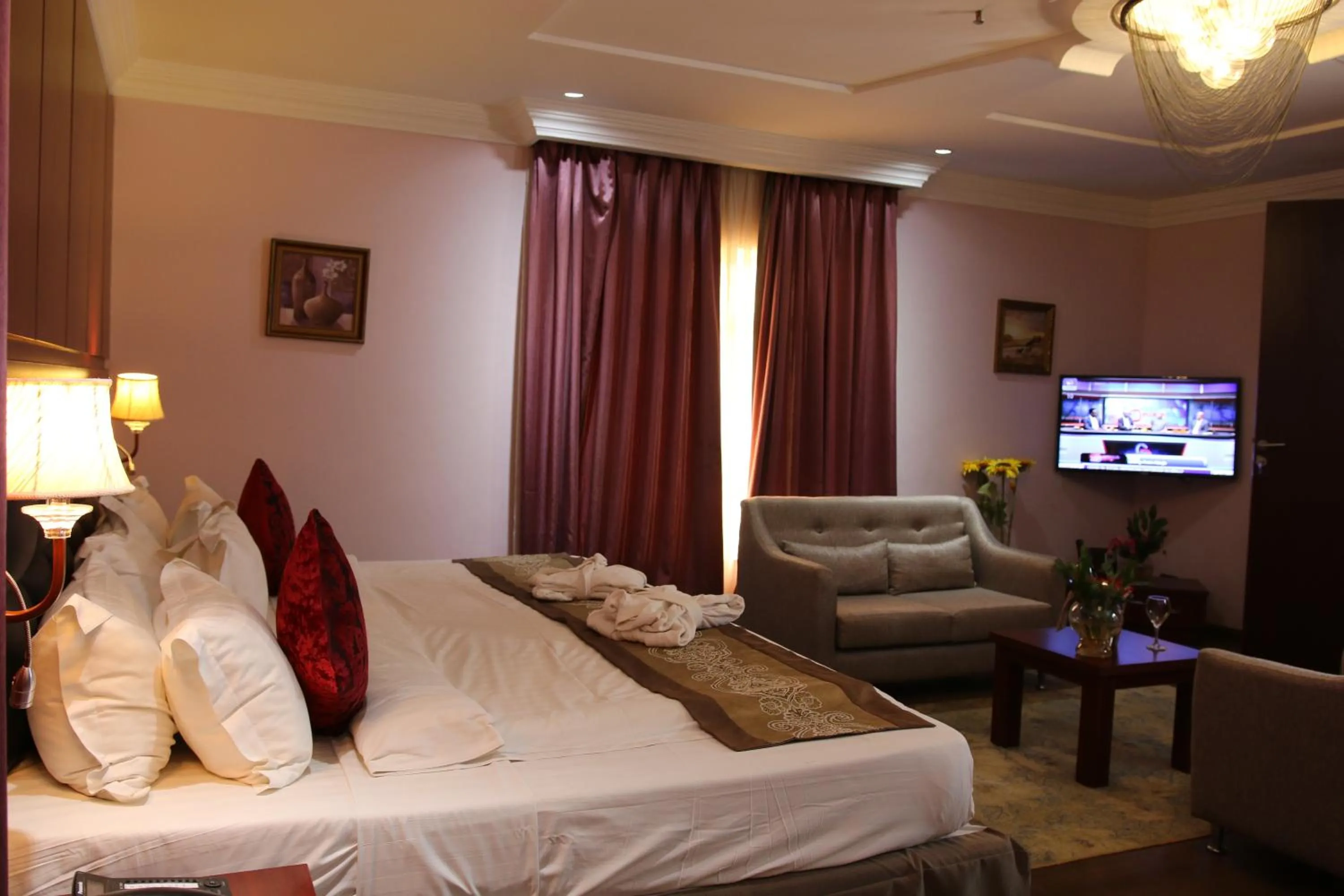 Bed in Grand Pela Hotel & Suites
