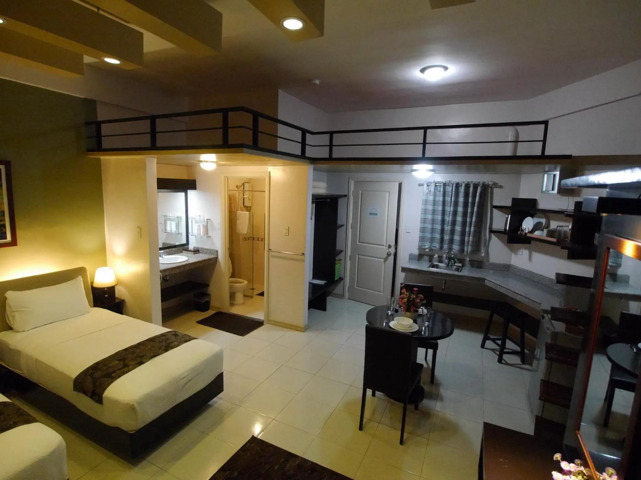 Photo of the whole room, Bed in New Manila Suites